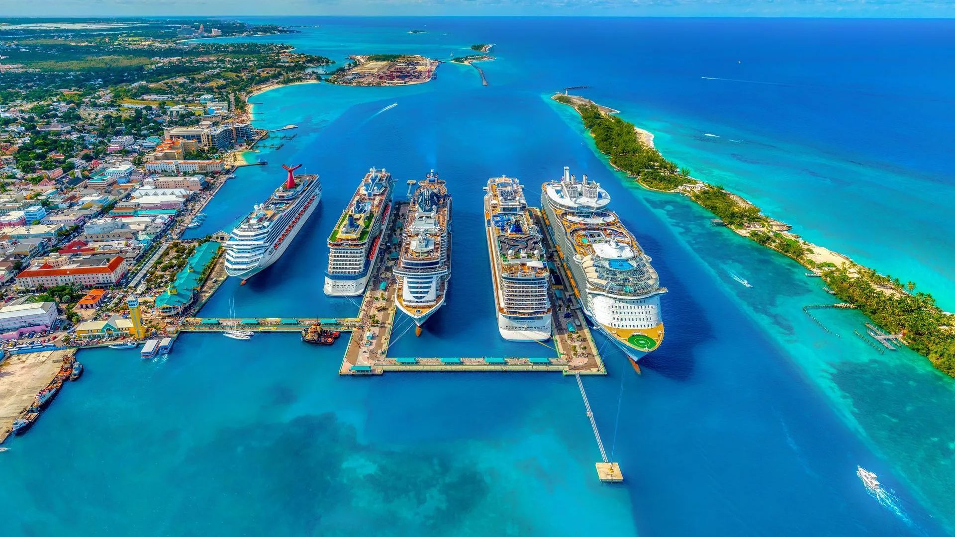 An aerial view of cruise ships docked in a harbor.