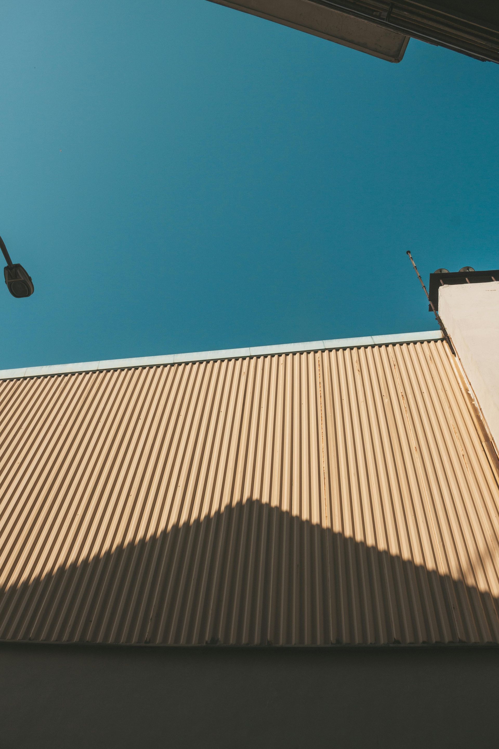 A close up of a roof with a blue sky in the background.