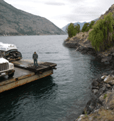Man With Trucks On The River — Chelan, WA — Jim’s Pumping Services, Inc.