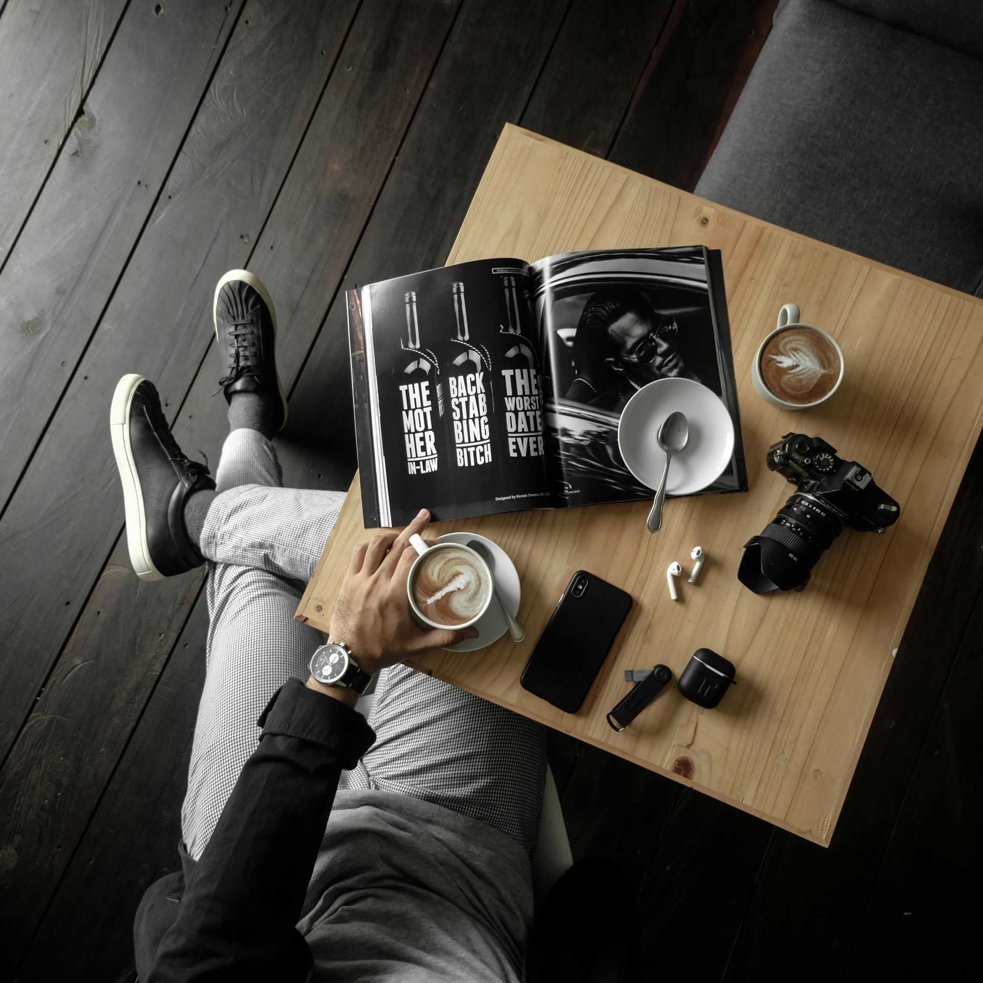 image of someone sitting at a desk reading with coffee