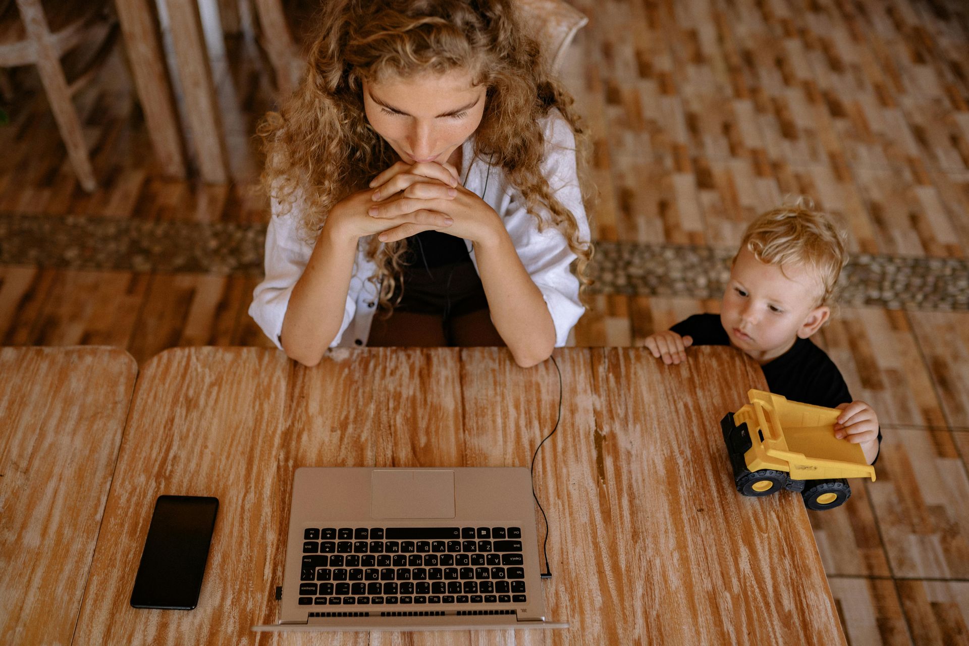 woman on her computer with her child