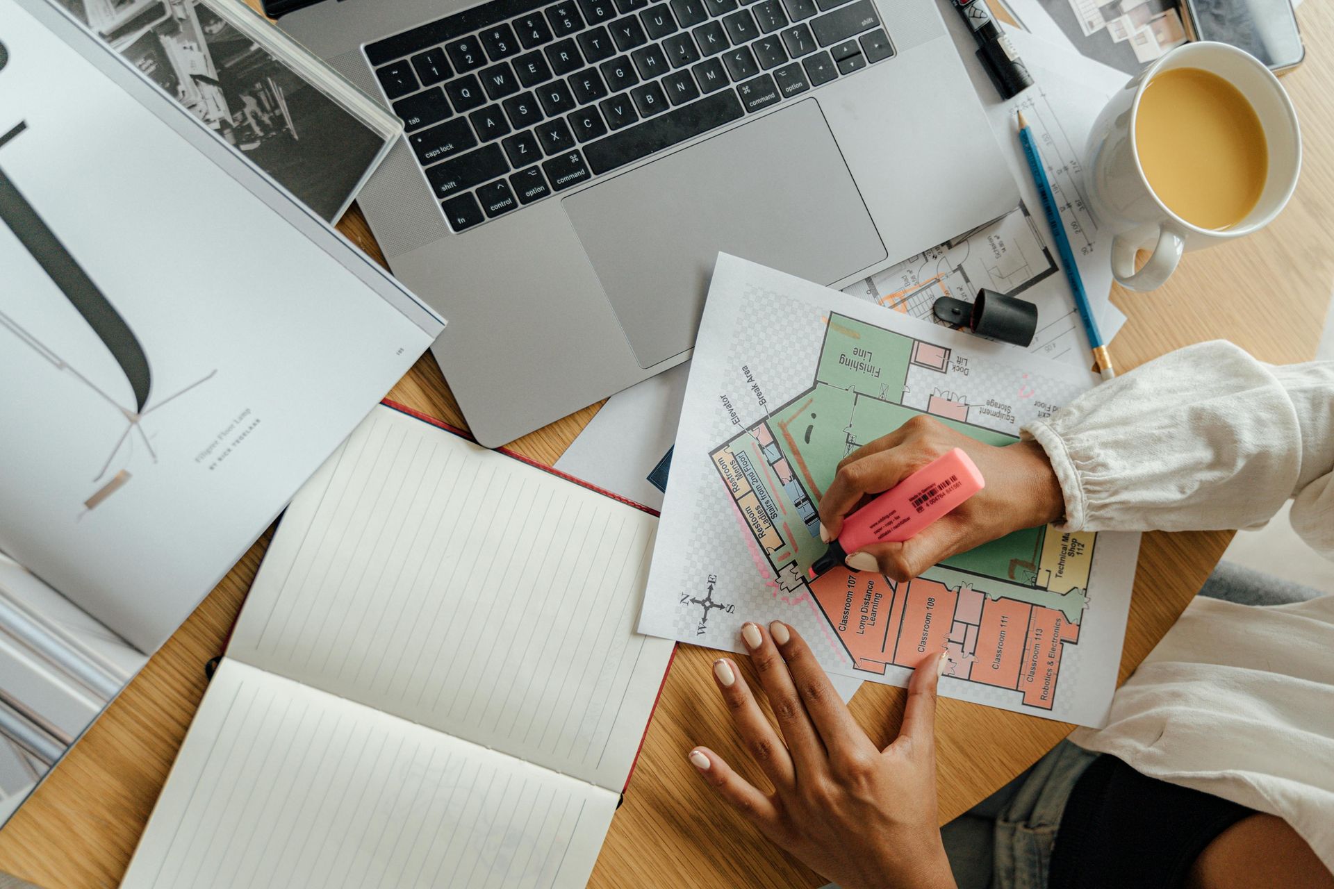 person drawing out architectural plans