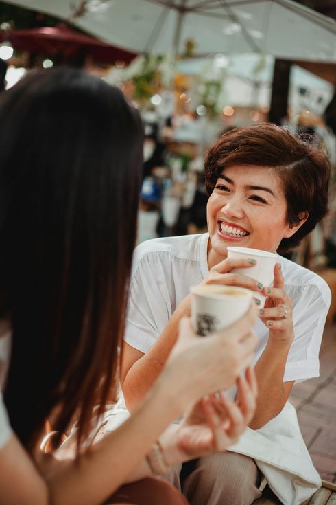 image of woman smiling drinking coffee