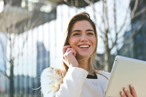 image of woman on her phone smiling