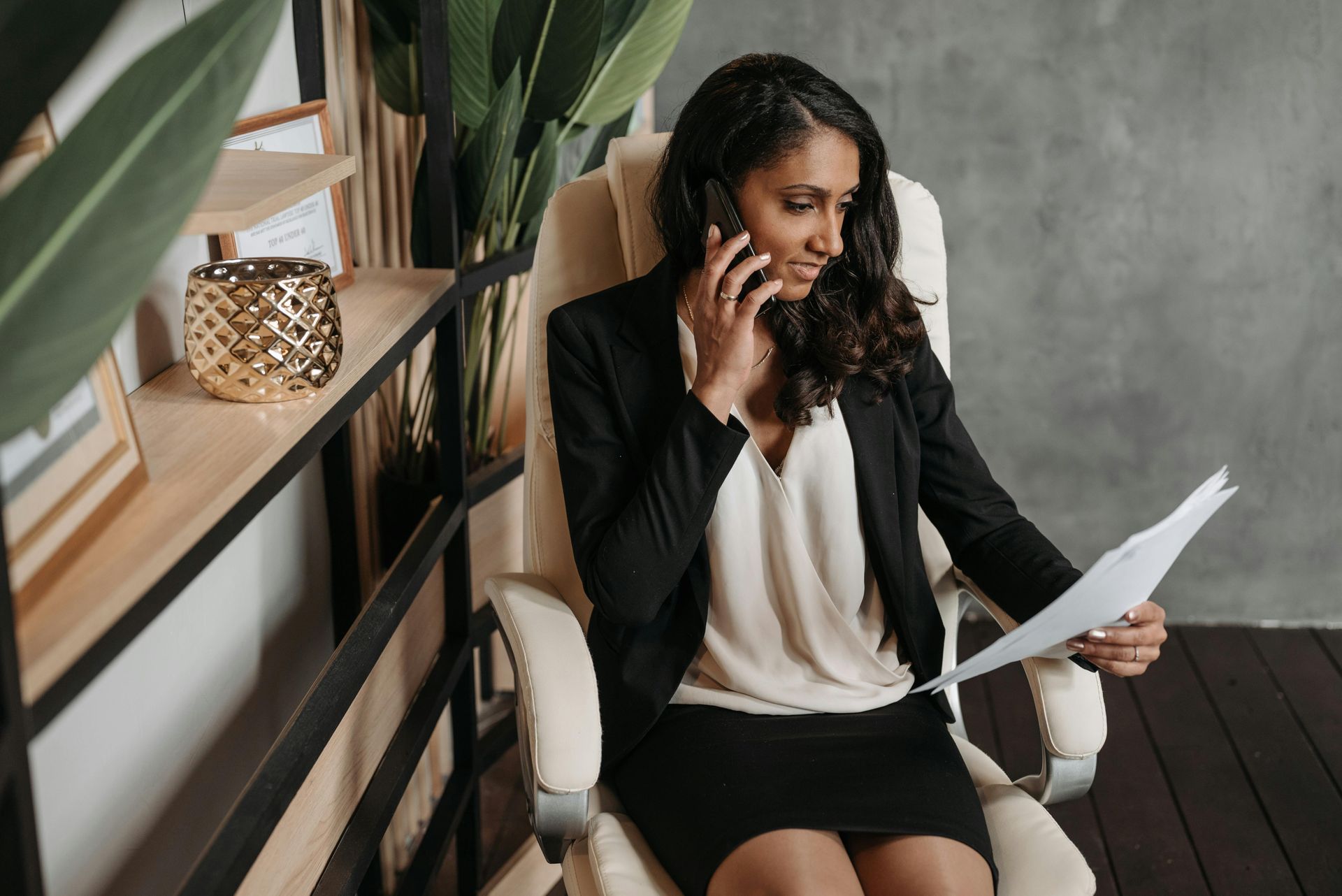 woman on the phone looking at paperwork