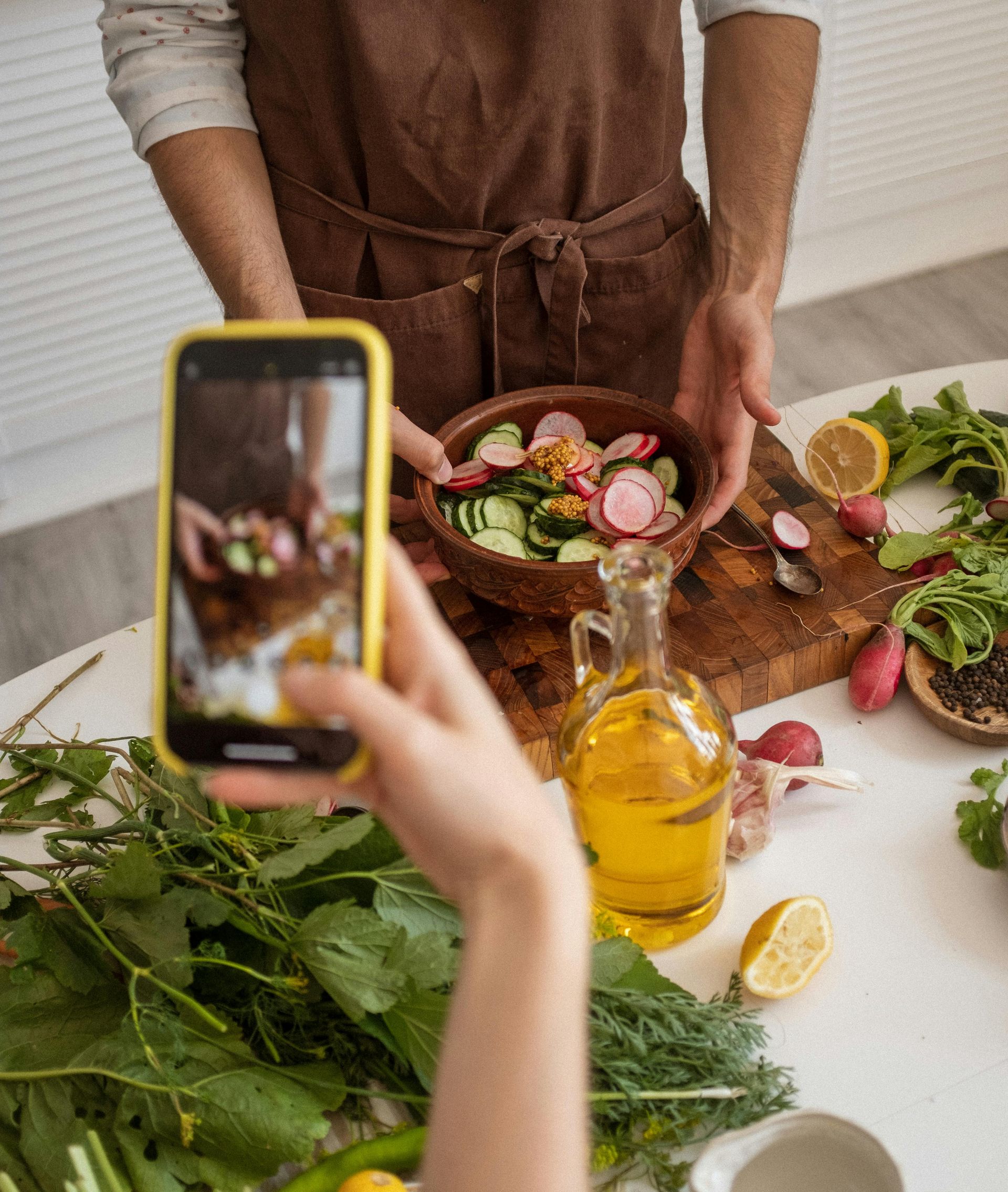 image of someone taking a picture of a salad