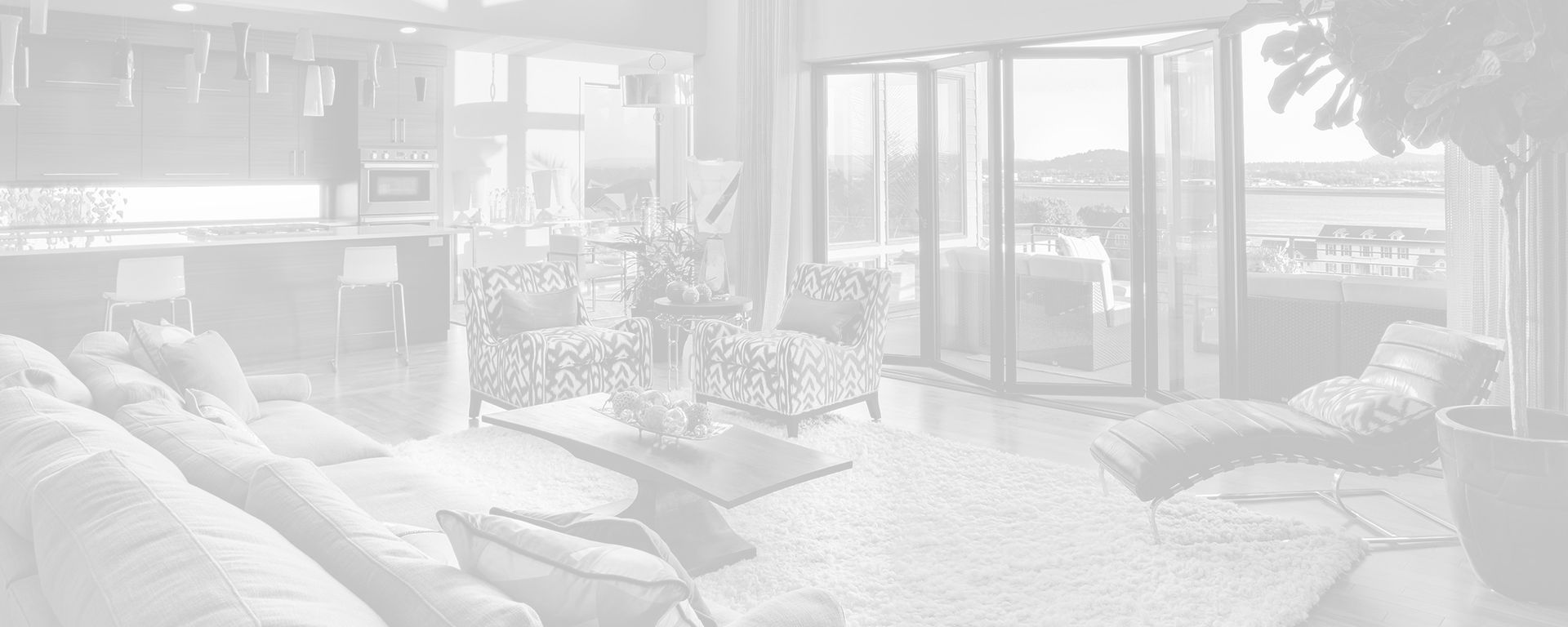 A living room with a couch, chairs, coffee table, and sliding glass doors.