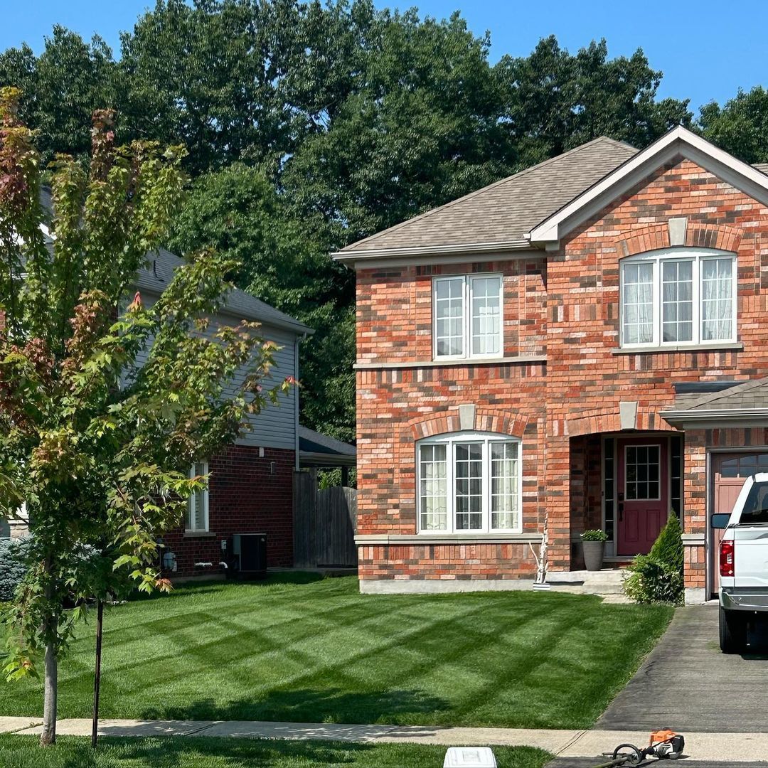 A brick house with a truck parked in front of it.