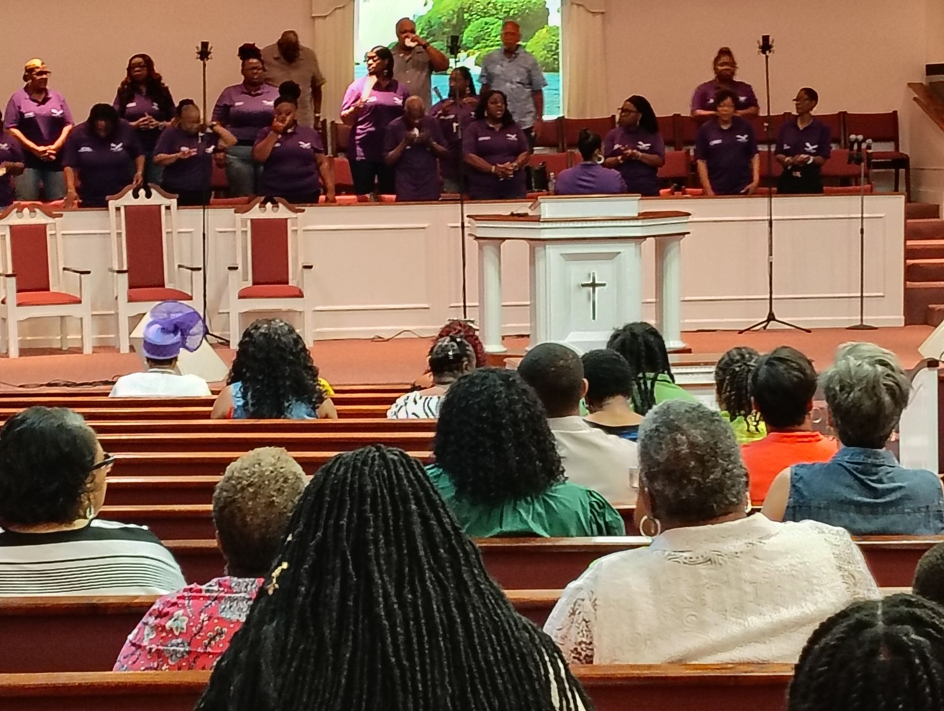 A group of people are standing in a church.