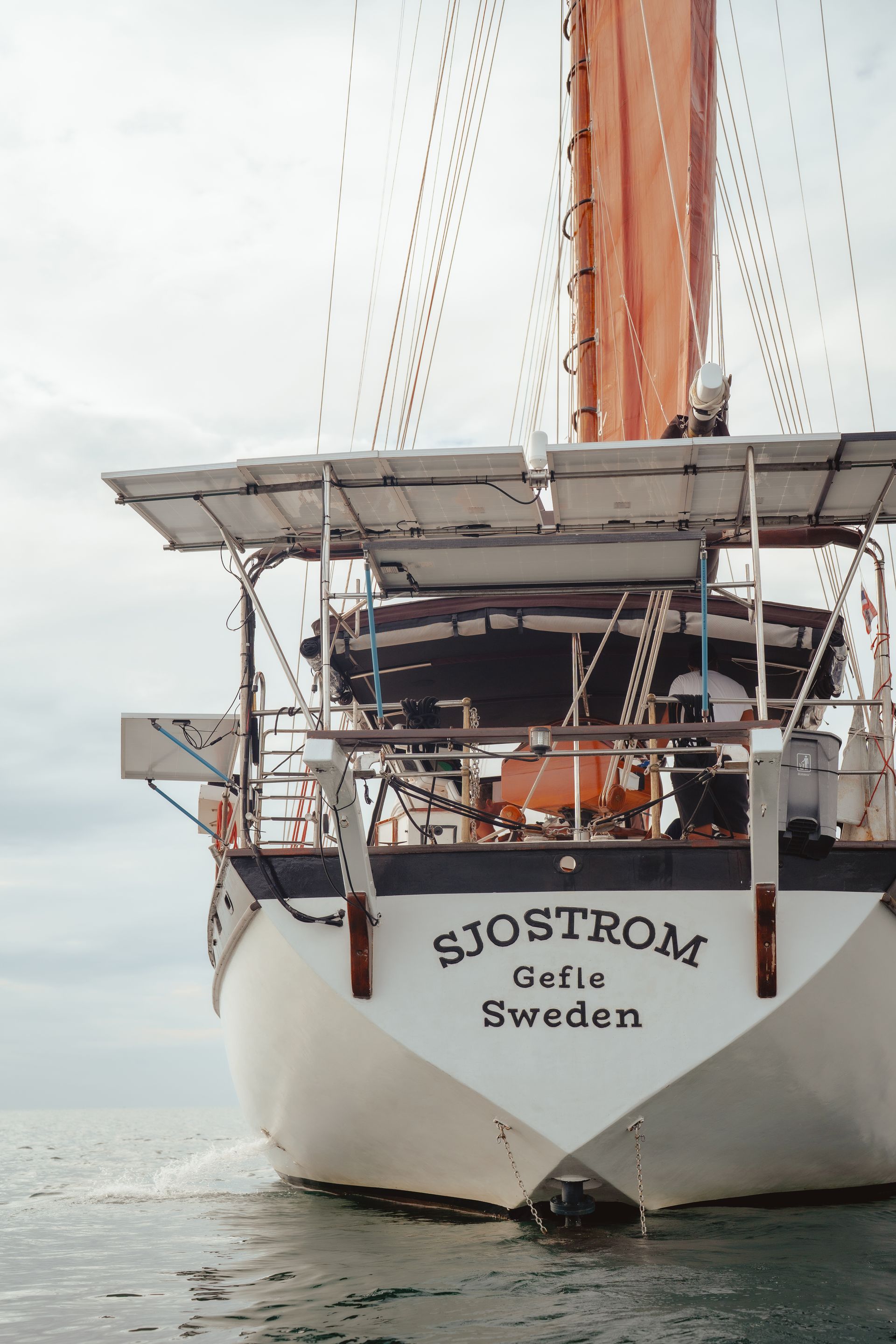 A sailboat - schooner - named sjostrom is in the water