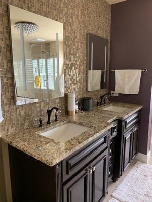 Two sinks and a large mirrors