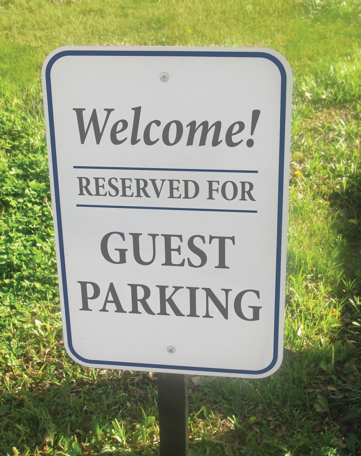 A white, rectangular parking sign with a blue border reads 