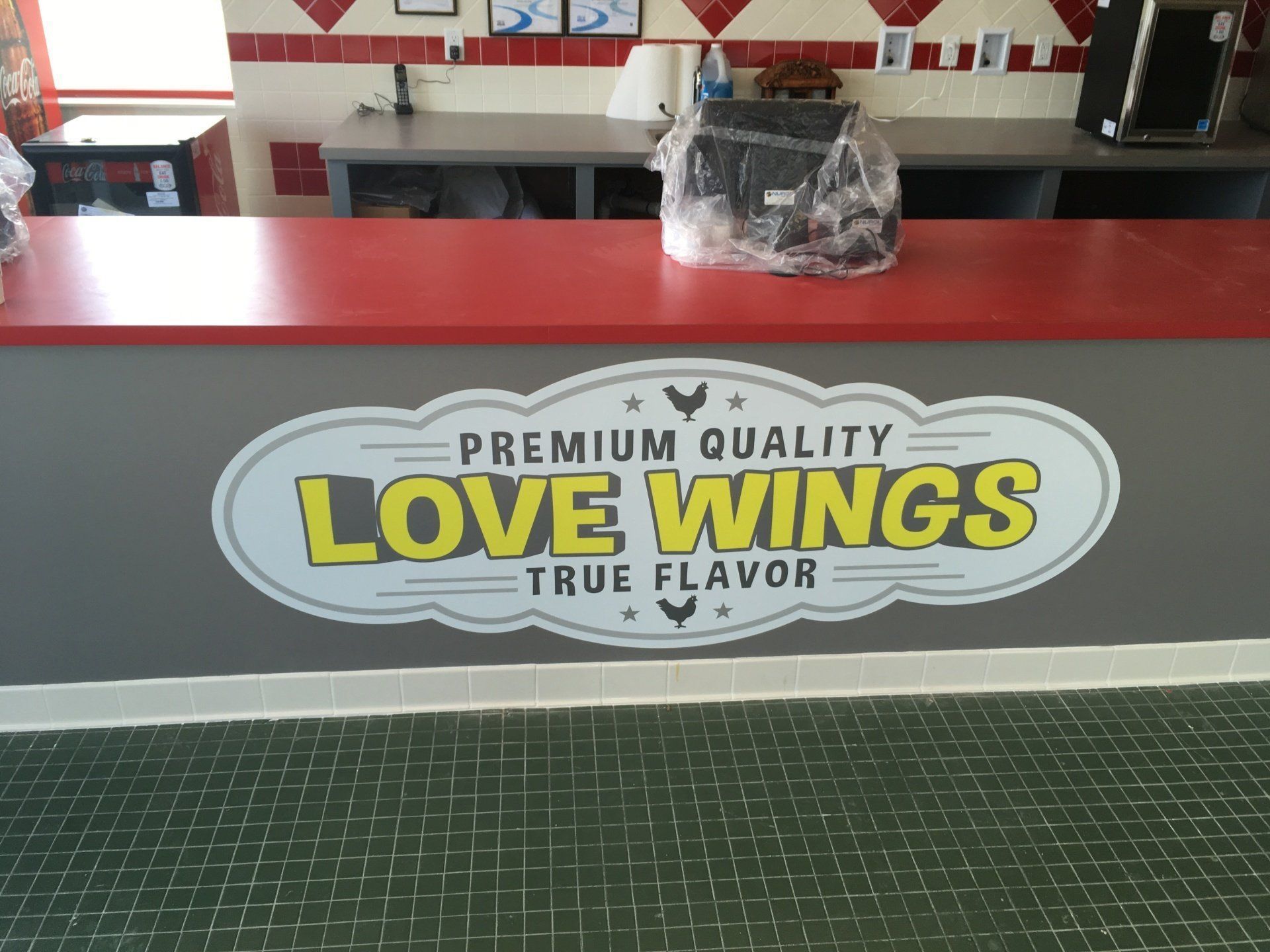 A service counter with a gray sign reading 