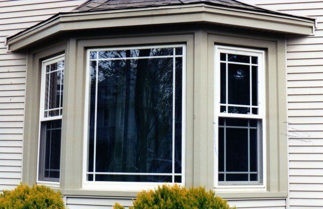 Bay window with sliding windows in tan trim Buffalo, NY