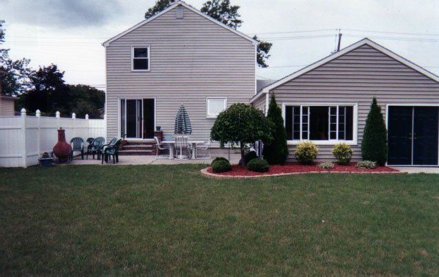 Patio doors and sliding windows in a grey vinyl sided house Amherst, NY