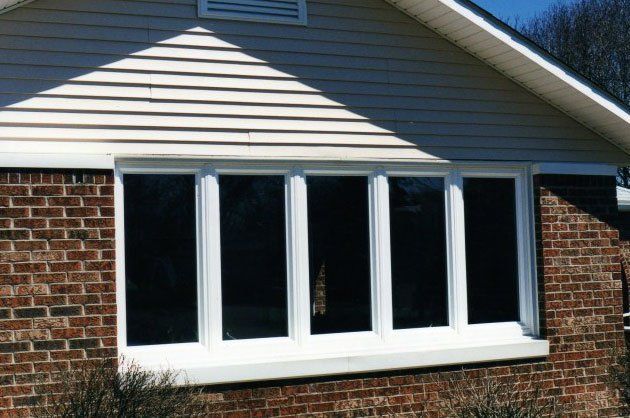 Multiple single panel windows connected by white trim Buffalo, NY