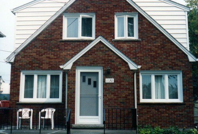 brick house front with sliding windows