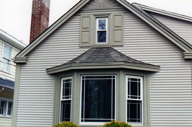 Window Installation of a three panel bay window and smaller window above with shutters Grand Island, NY