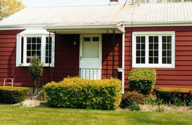 Casement windows installed in a red vinyl-sided home Grand Island, NY