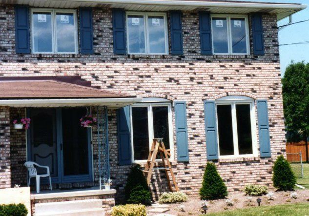 Multiple sliding windows set in a brick home Buffalo, NY