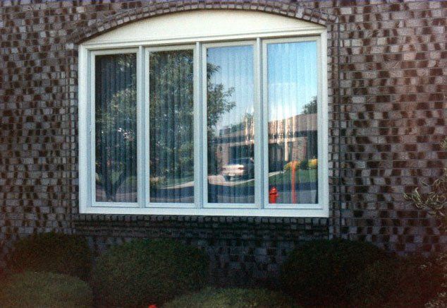 Tall sliding windows with arched trim Grand Island, NY