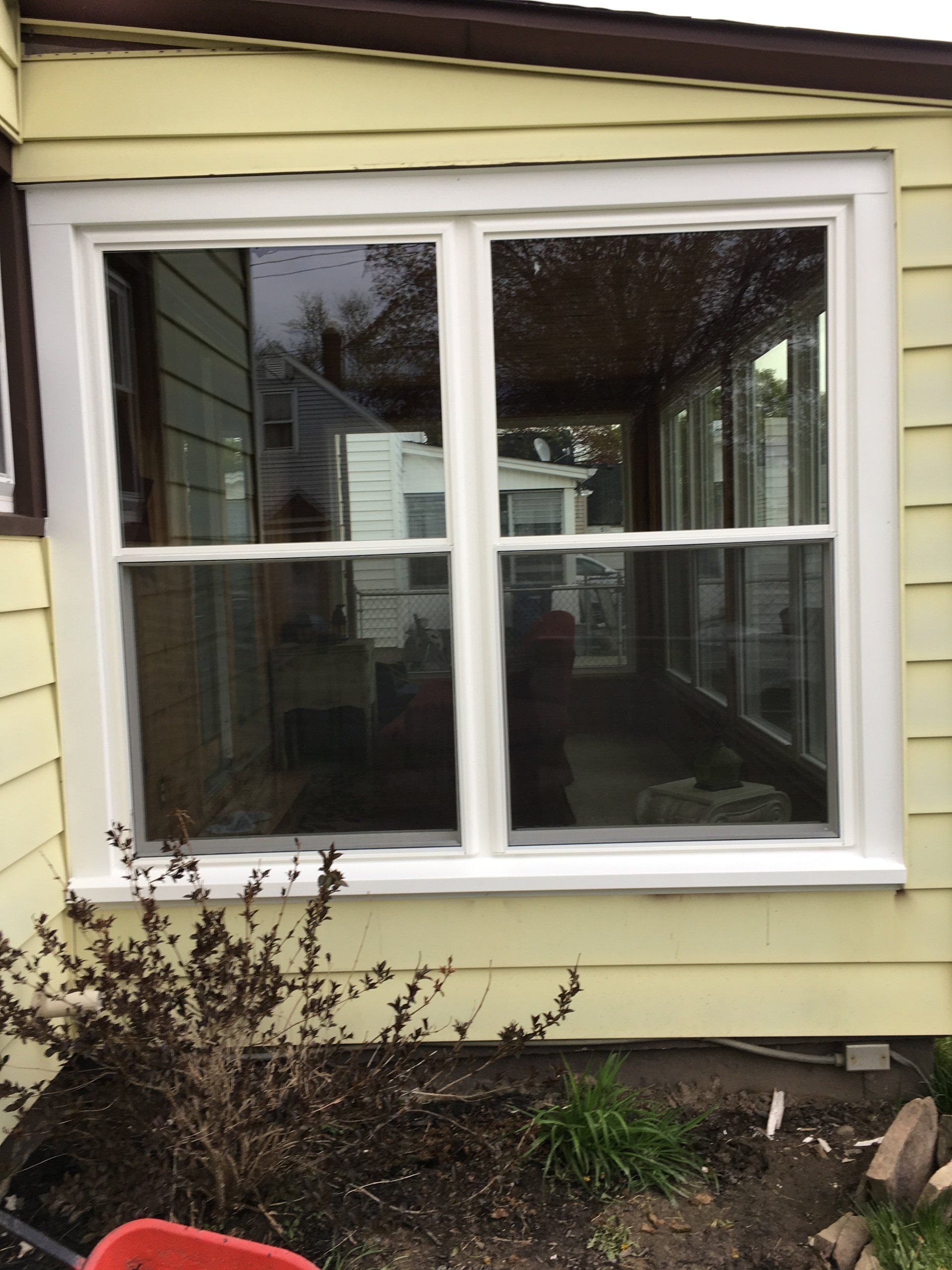 large window on yellow house