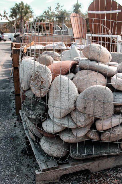 a pile of rocks is sitting on the ground .