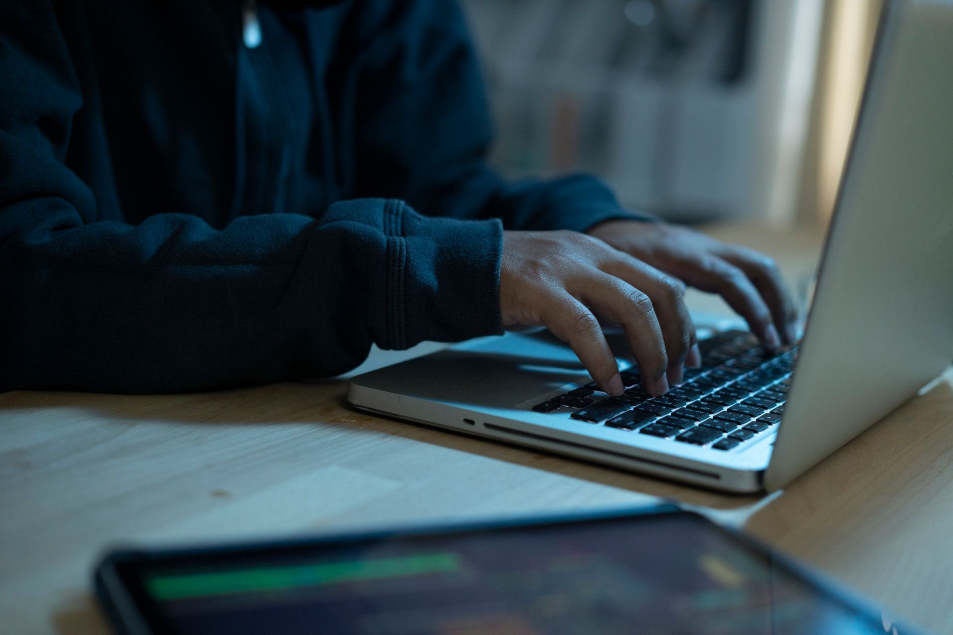A person is typing on a laptop computer.