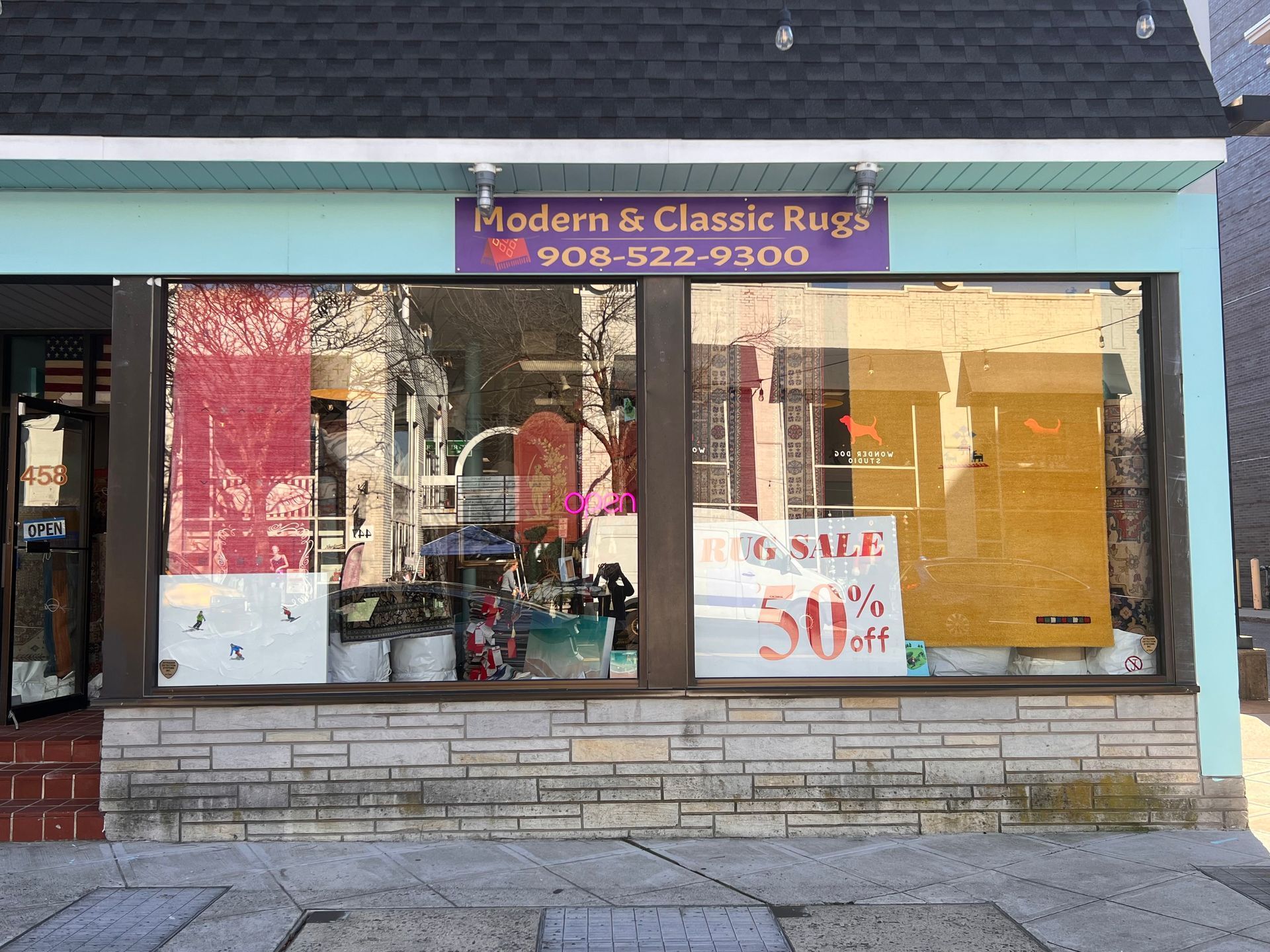 A store front with a sign that says modern & classic rugs