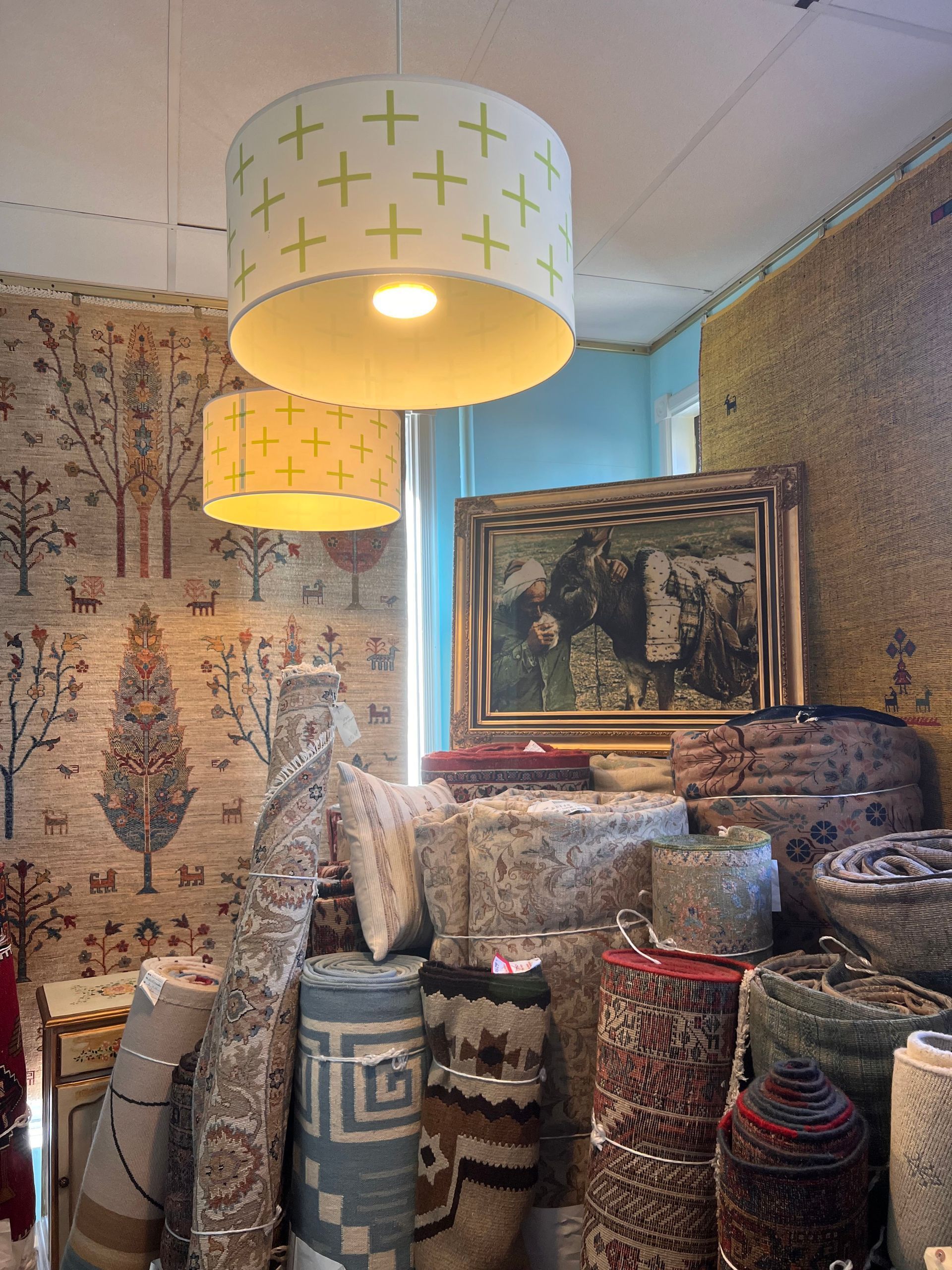 A room filled with lots of rugs and lamps