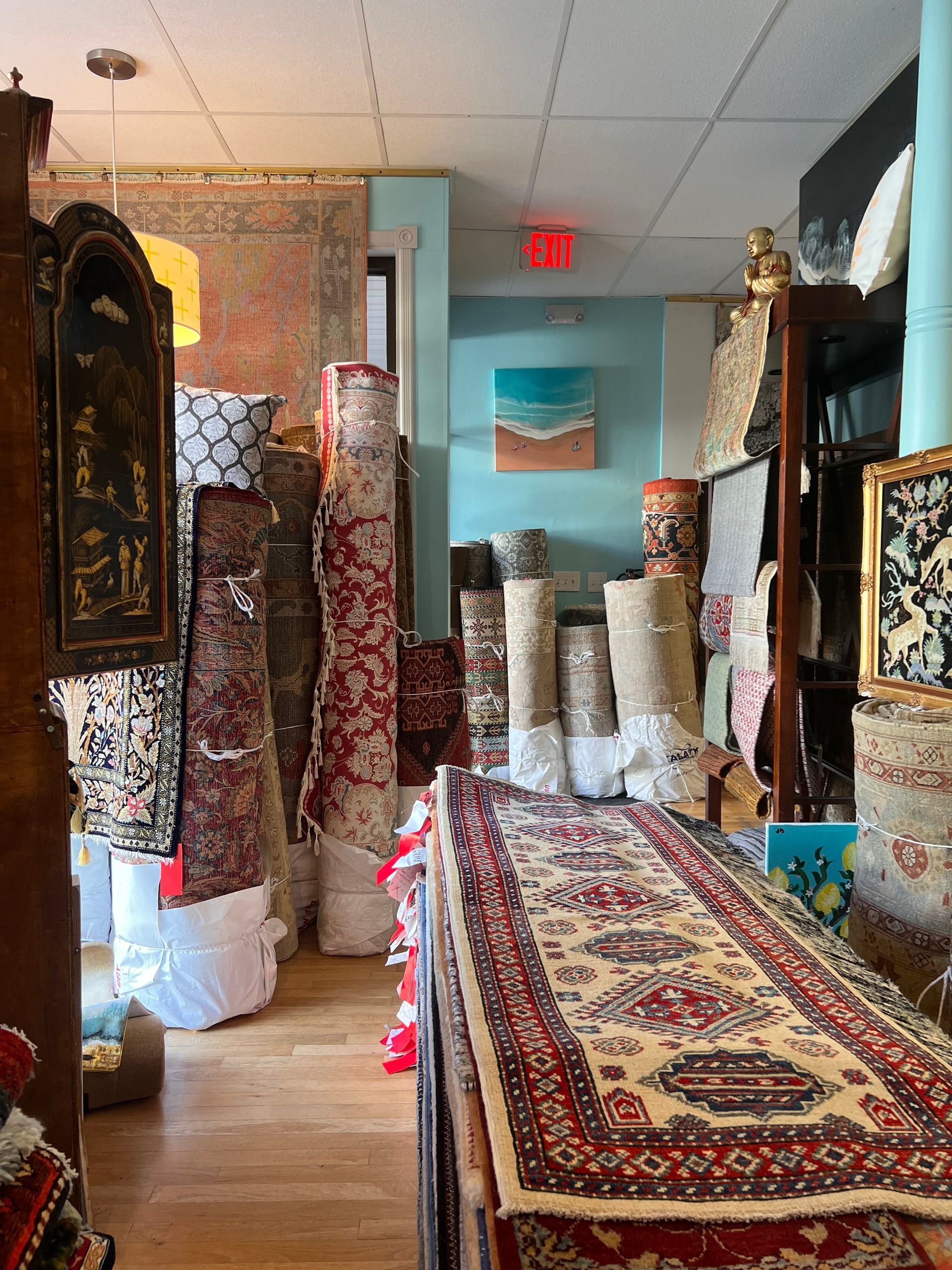 A room filled with lots of rugs and a clock.