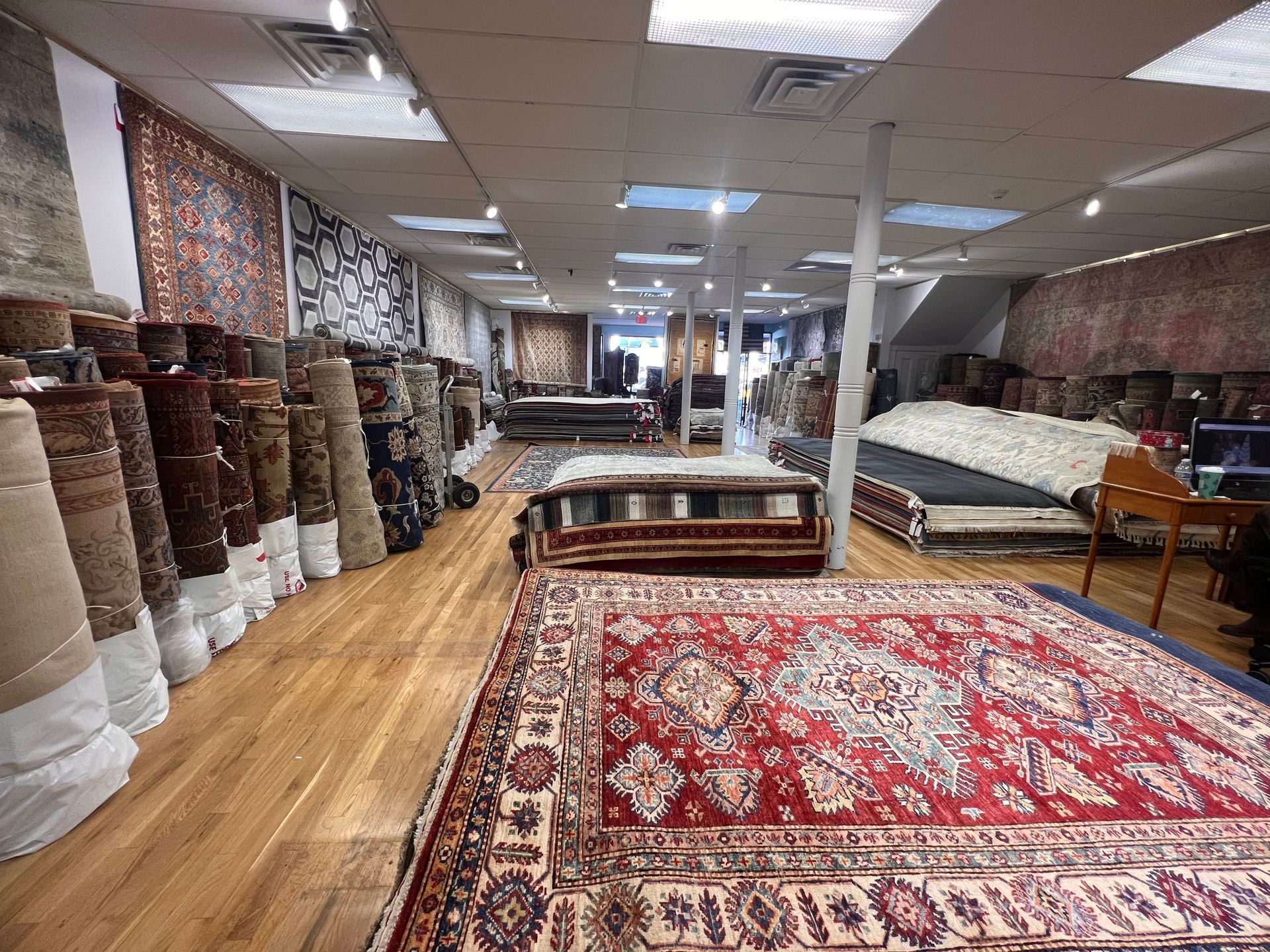 A large room filled with lots of rugs and furniture.