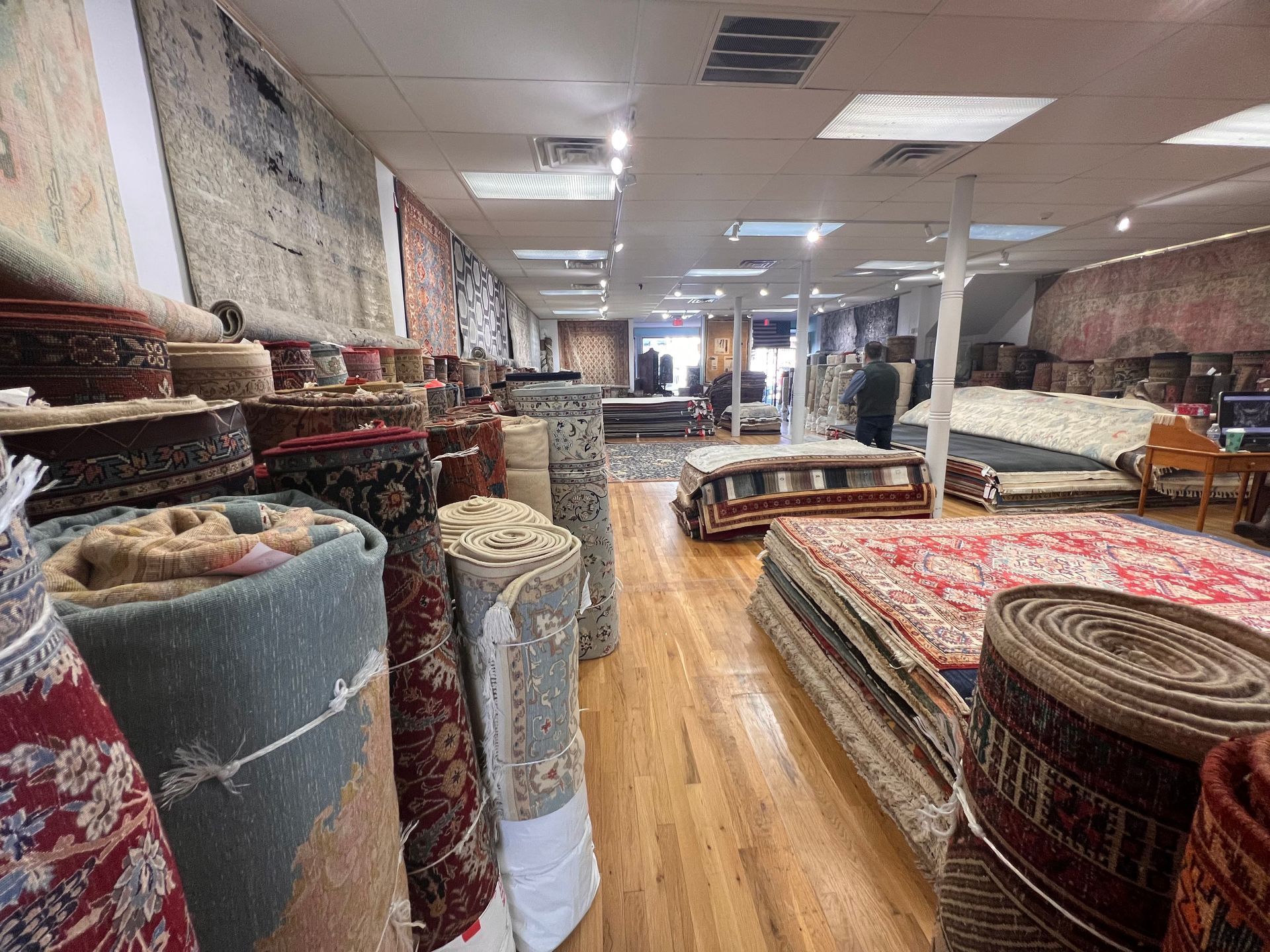 A large room filled with lots of rugs and carpets.