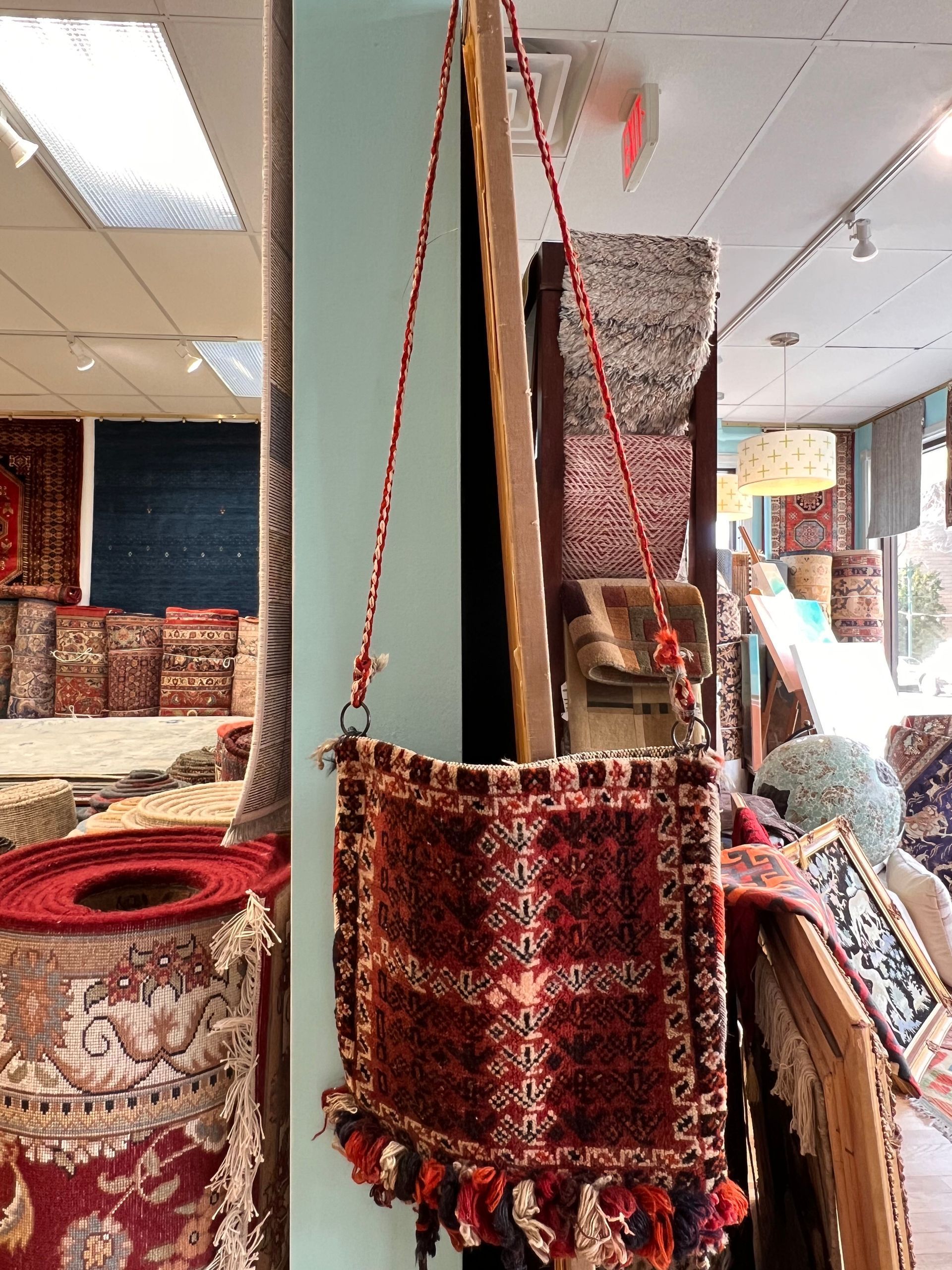 A purse is hanging on a wall in a store