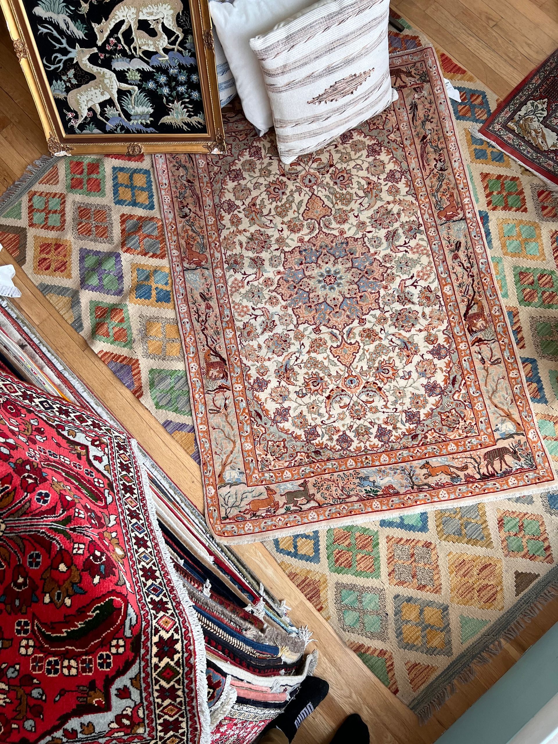 A living room filled with lots of colorful rugs and pillows.