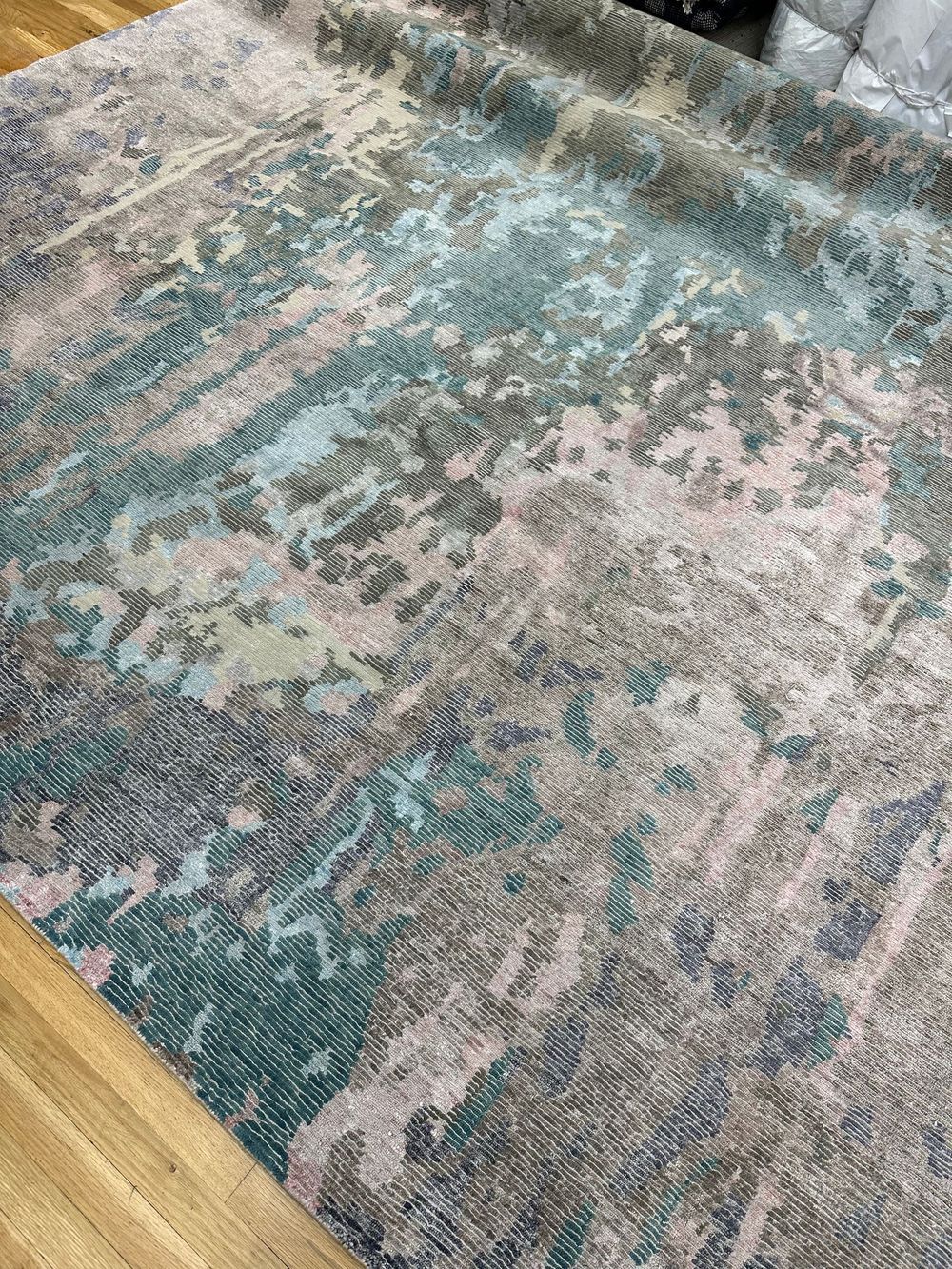 A rug is sitting on top of a wooden floor.