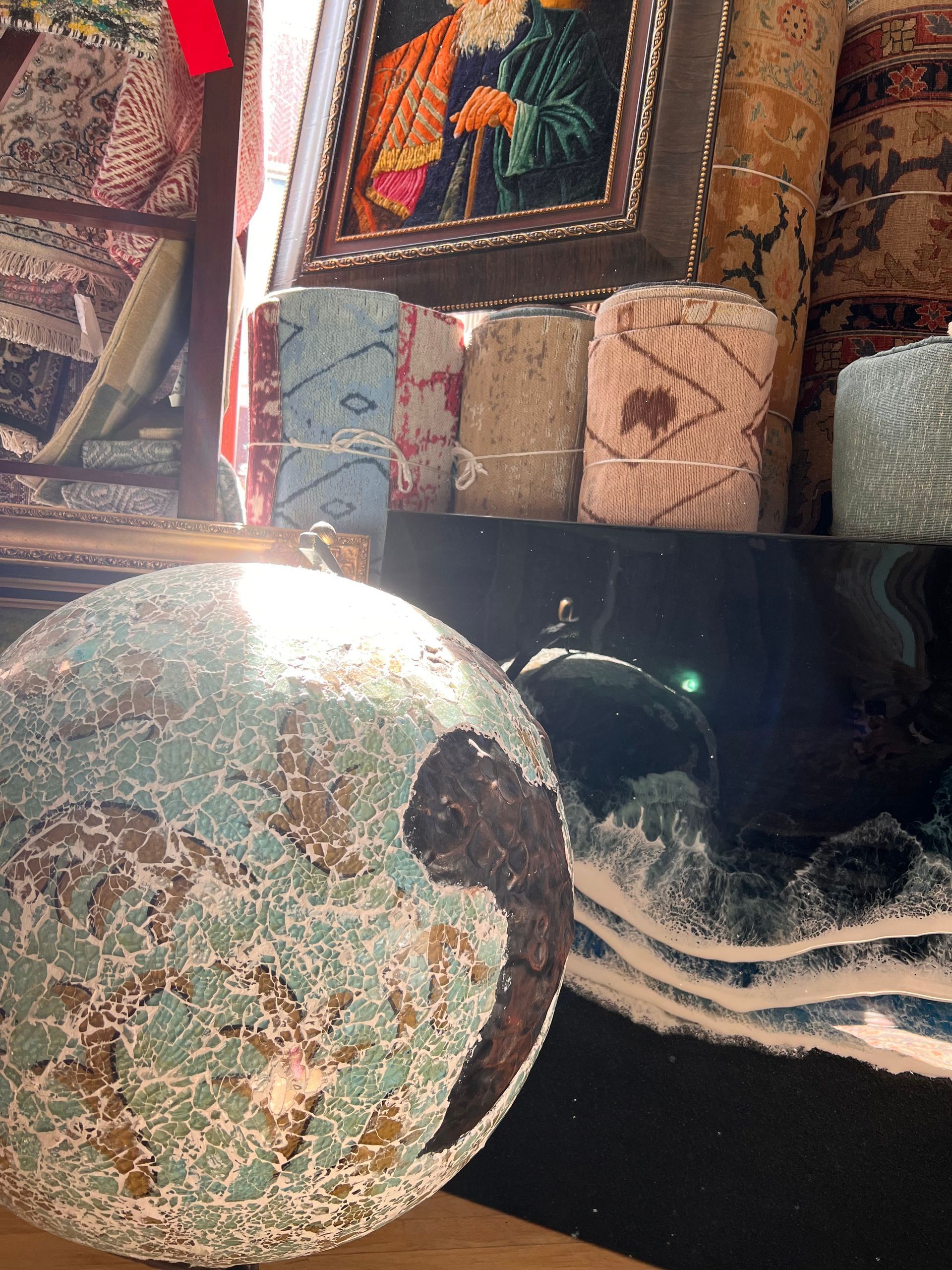 A globe with a turtle on it is sitting on a table