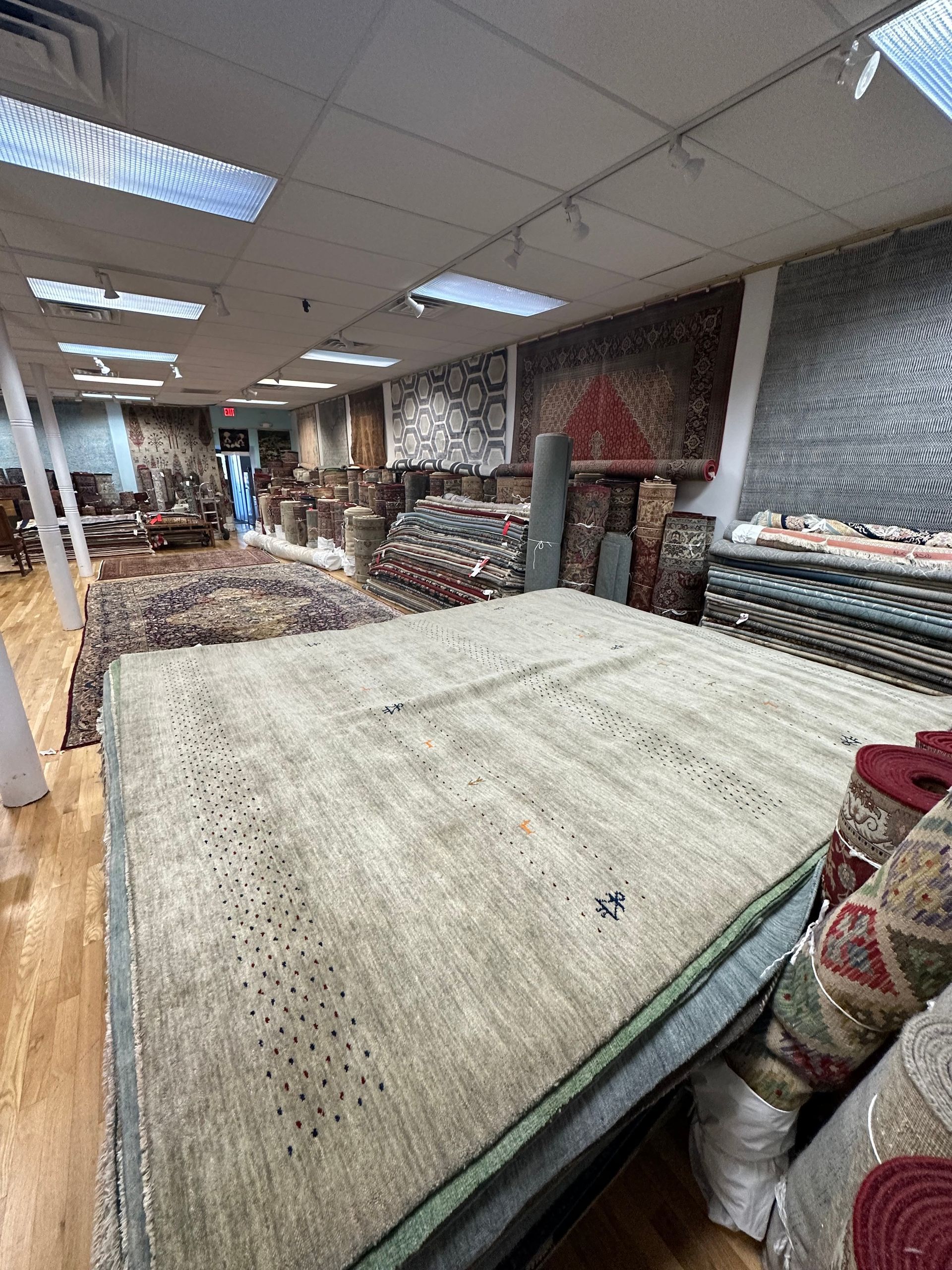 A large room filled with lots of rugs and carpets.