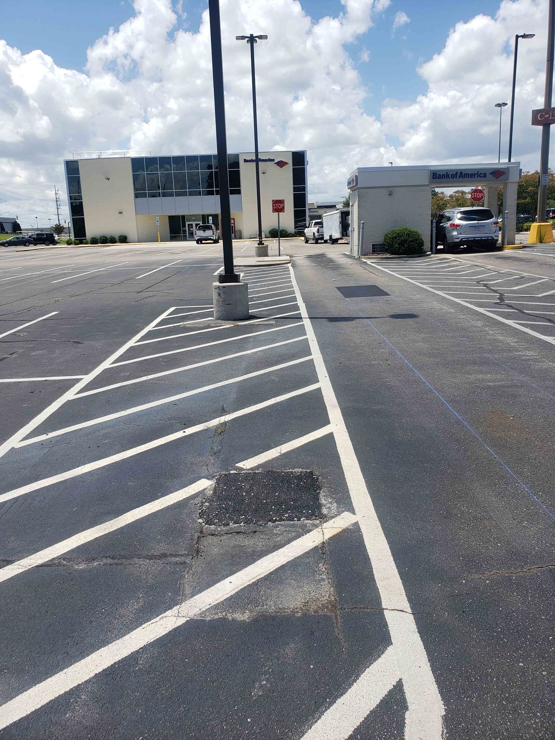 A parking lot with a building in the background