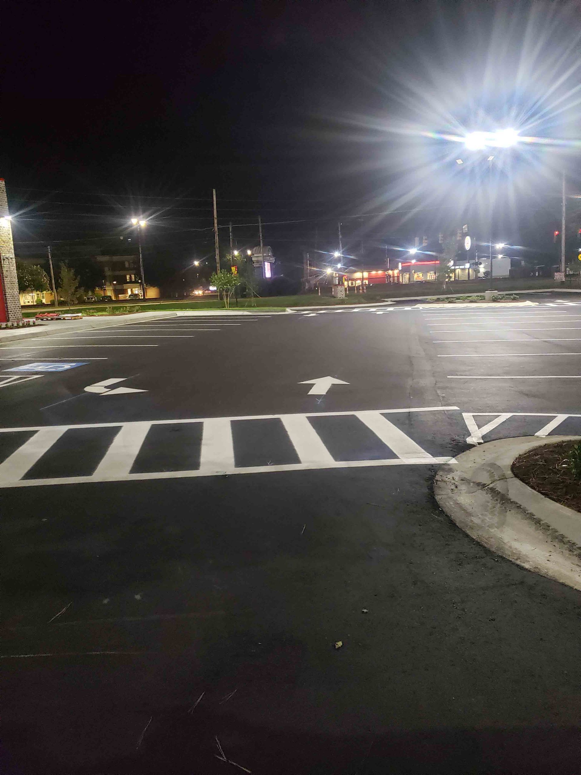A parking lot at night with a lot of lights on it.