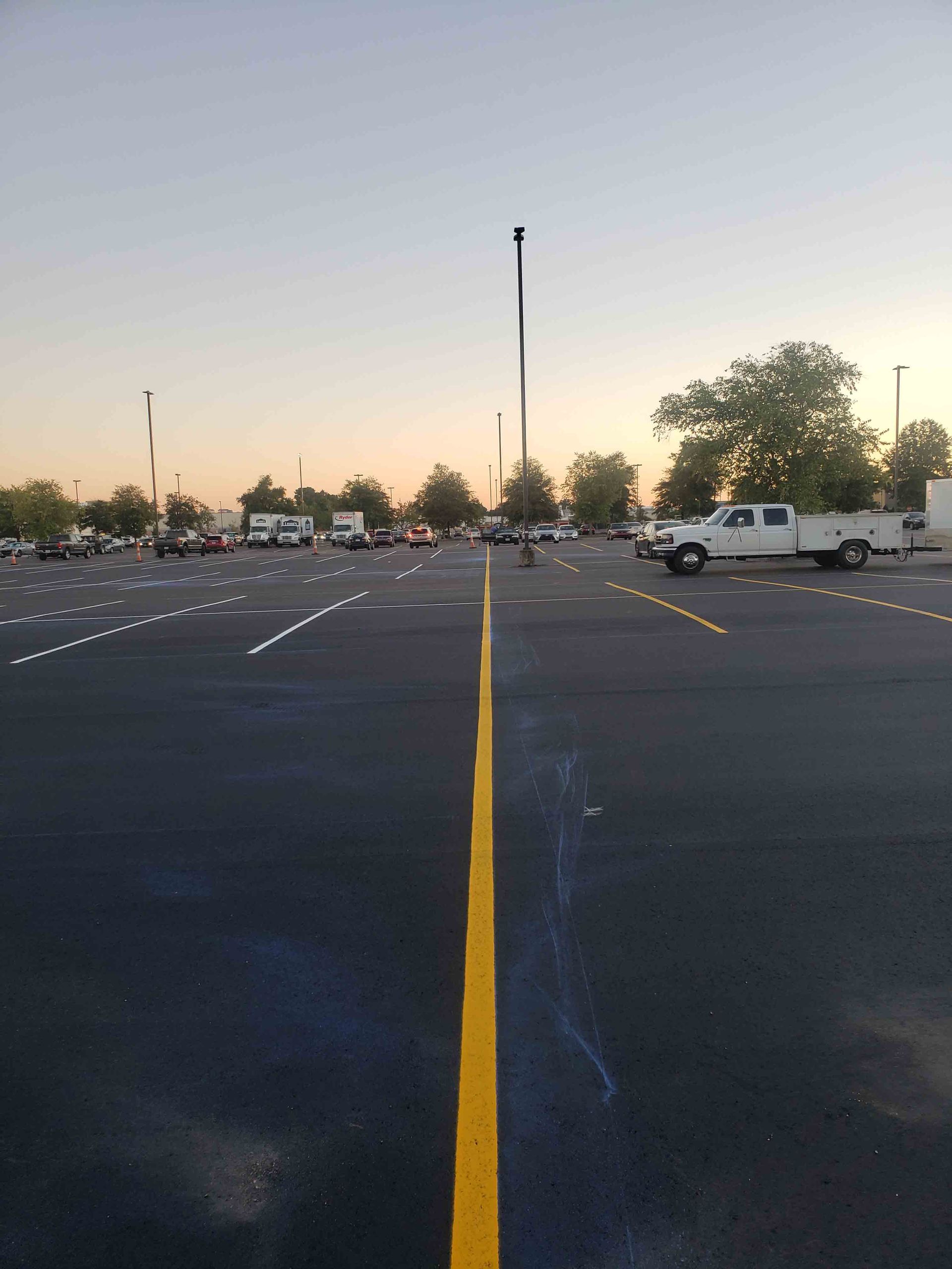 A parking lot with a yellow line in the middle