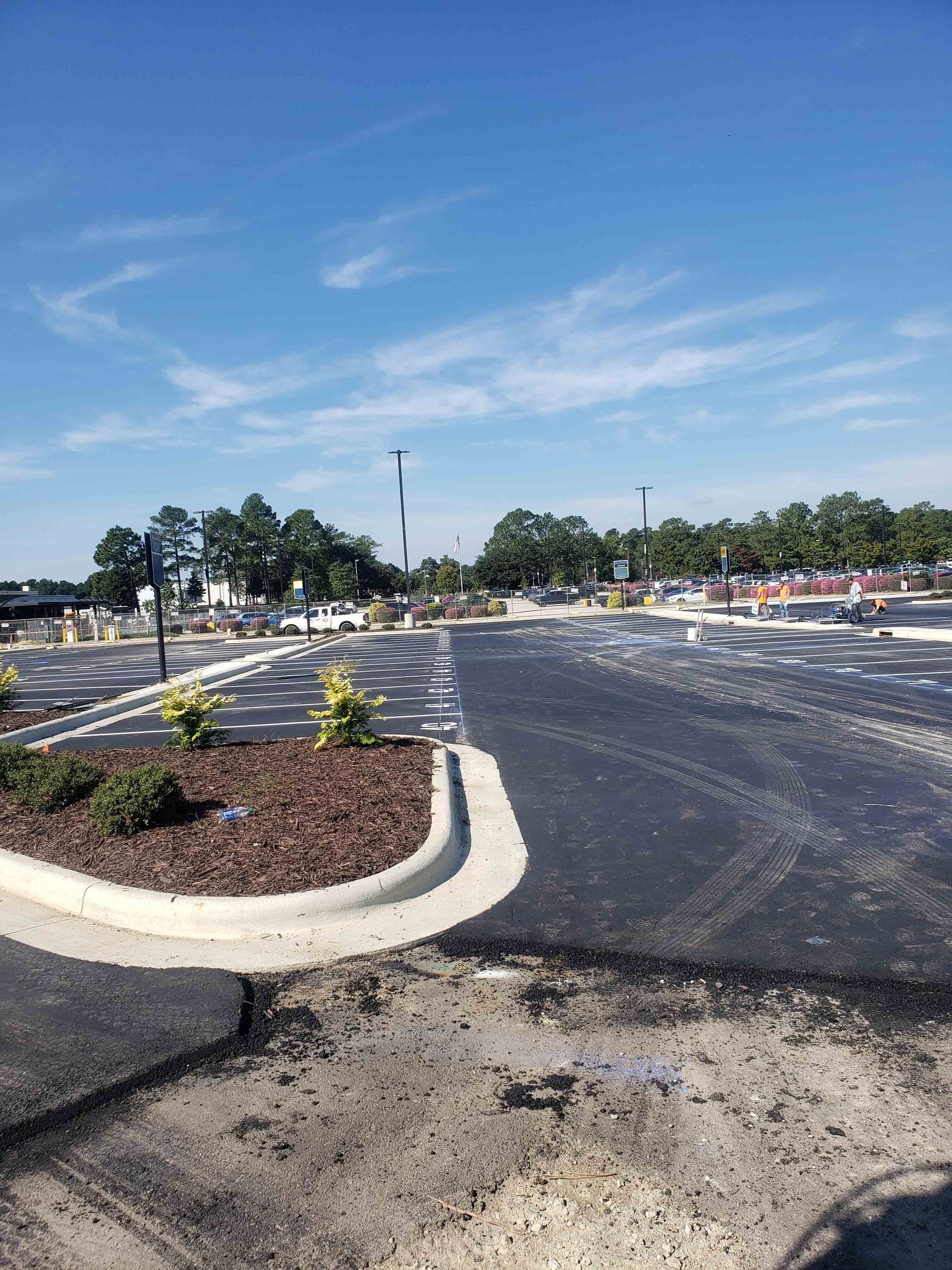 A parking lot with a lot of cars parked in it on a sunny day.