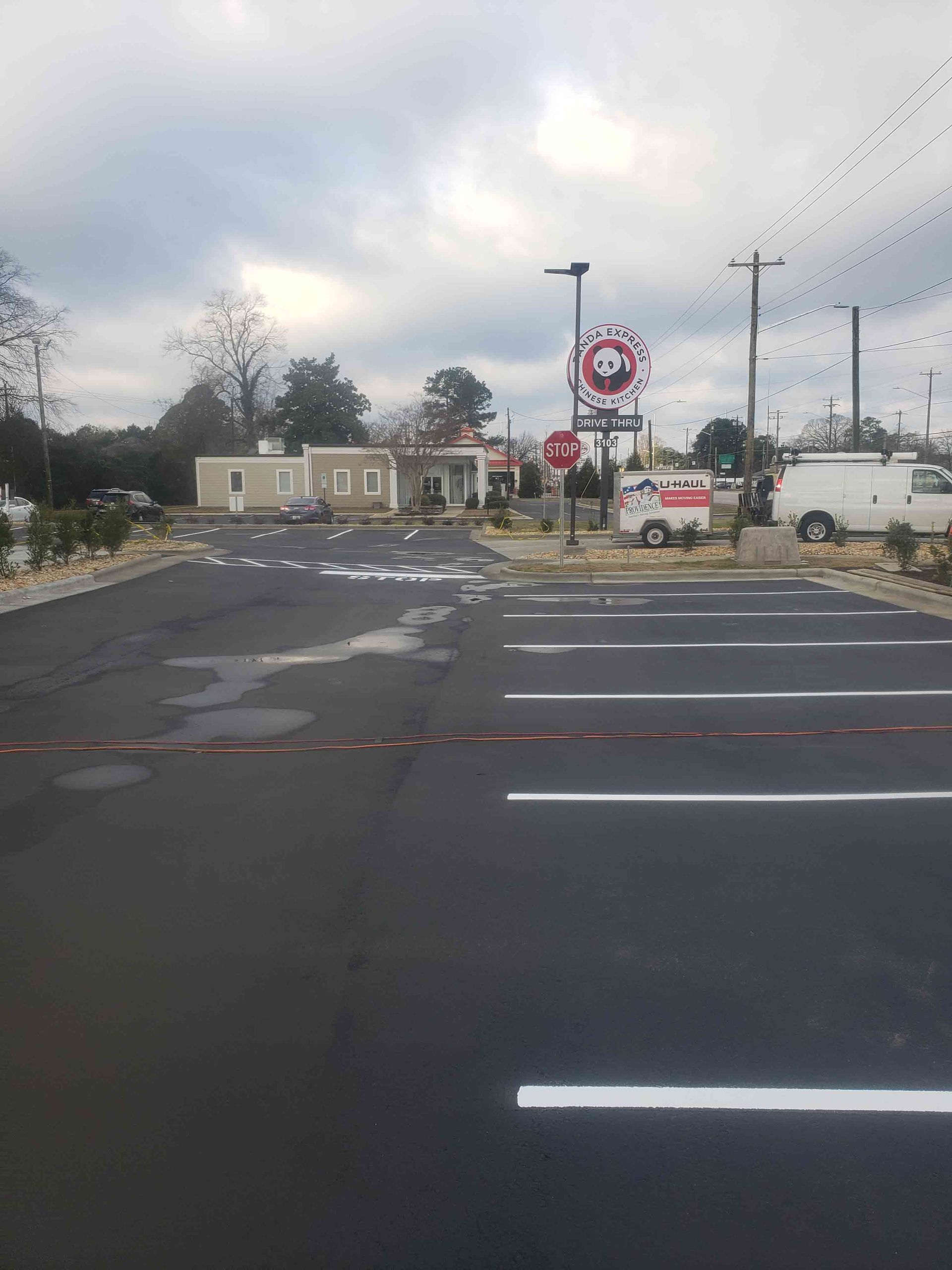 A parking lot with a panda express sign in the background