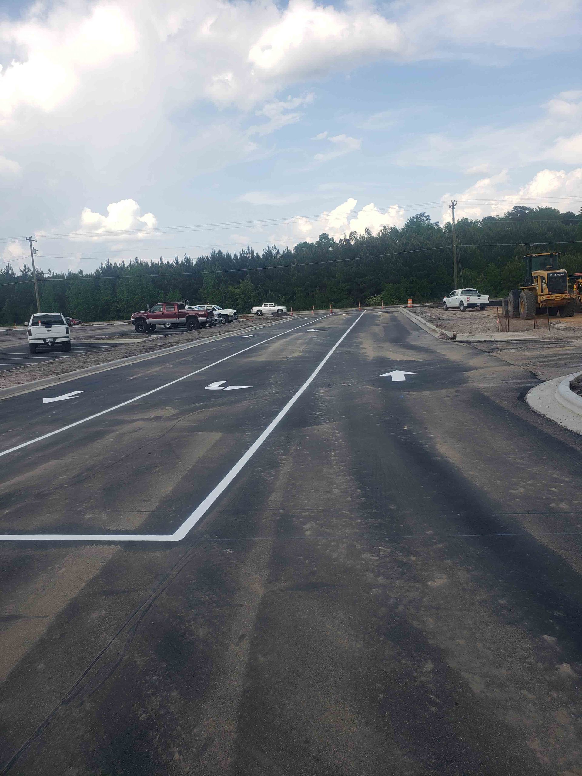 A row of trucks are parked on the side of a road.