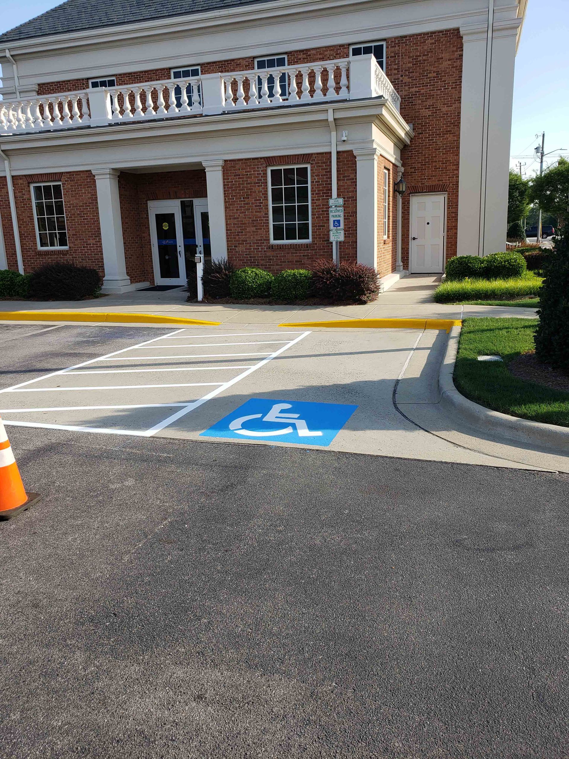 A handicapped parking spot in front of a brick building