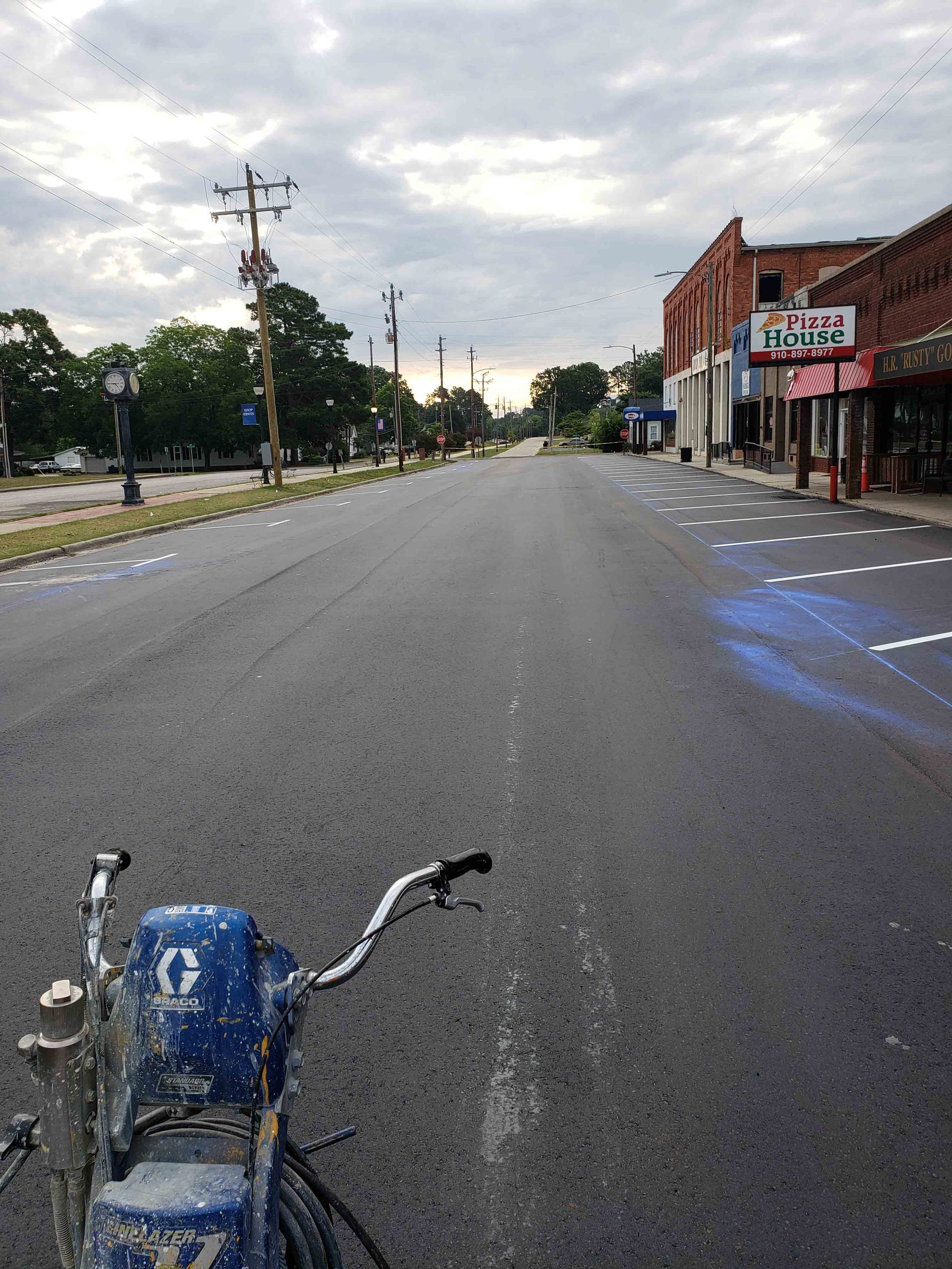 A blue motorcycle is parked on the side of a road