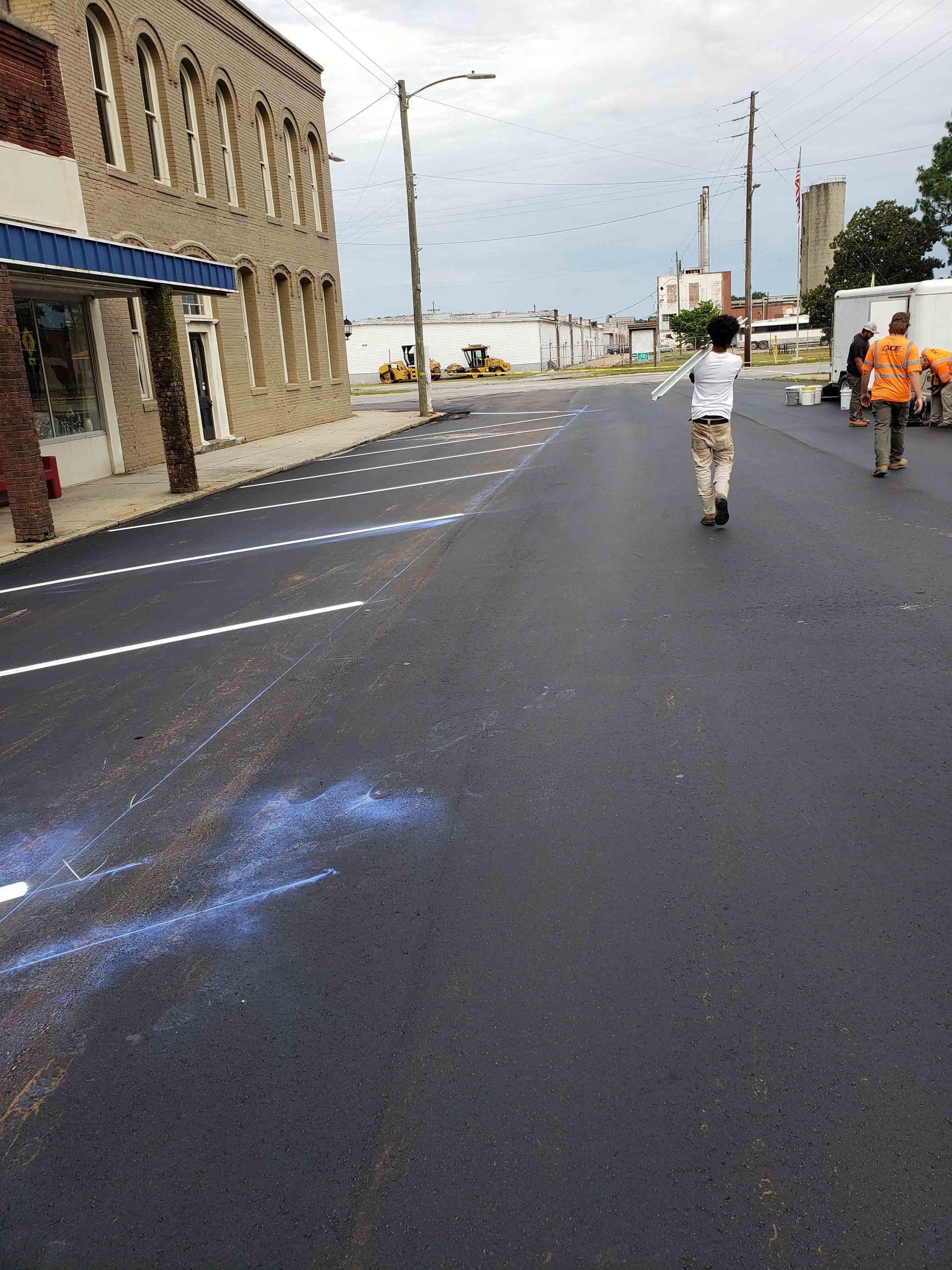 A group of people are walking down a street.