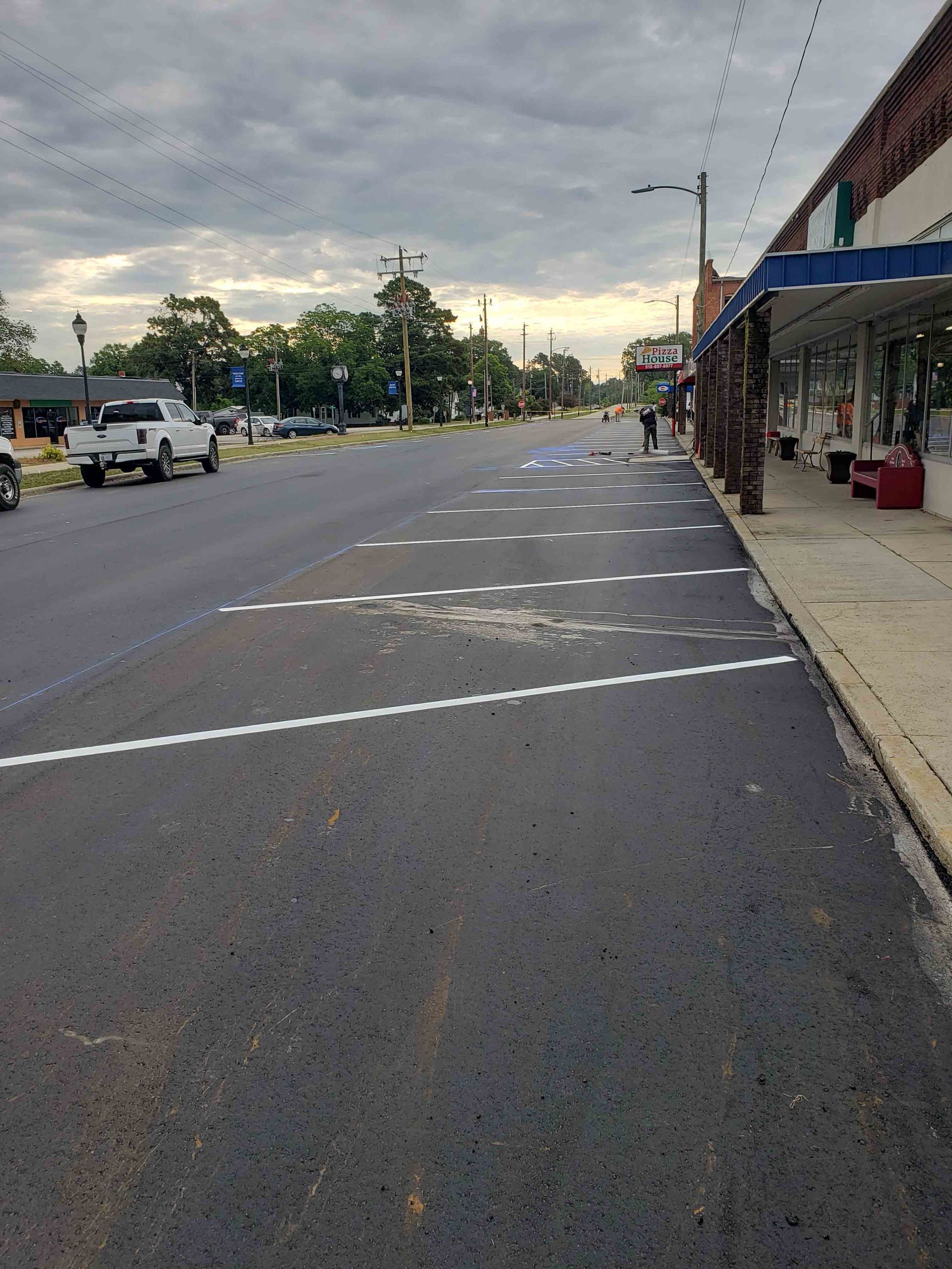 A street with a lot of cars driving down it