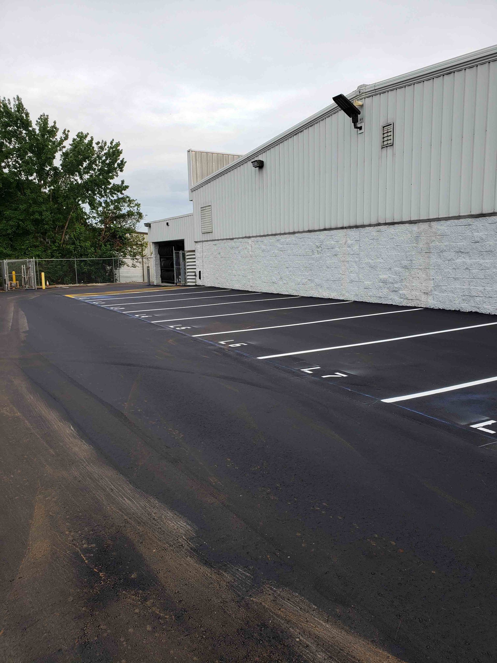 A large white building with a parking lot in front of it
