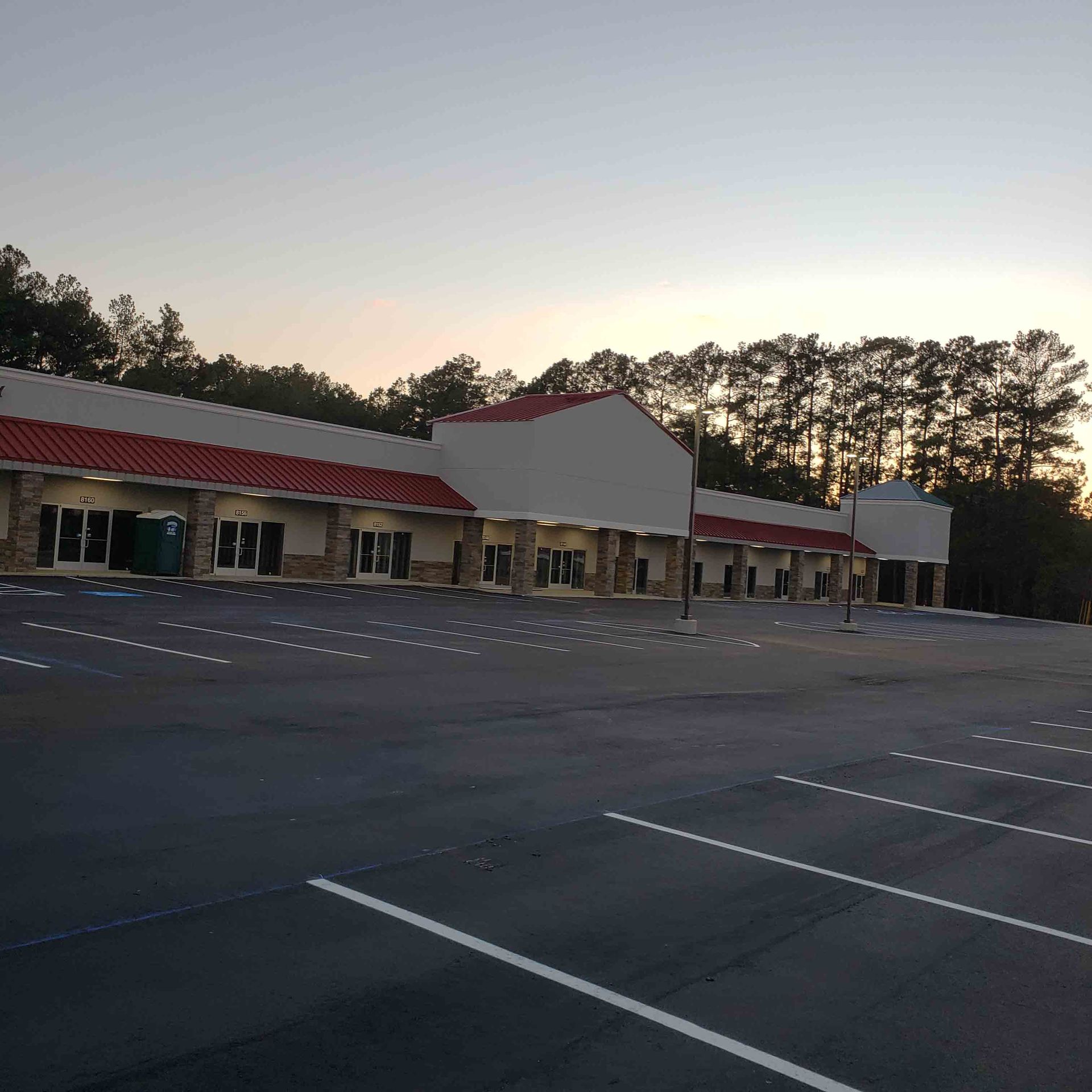 A parking lot with a building in the background